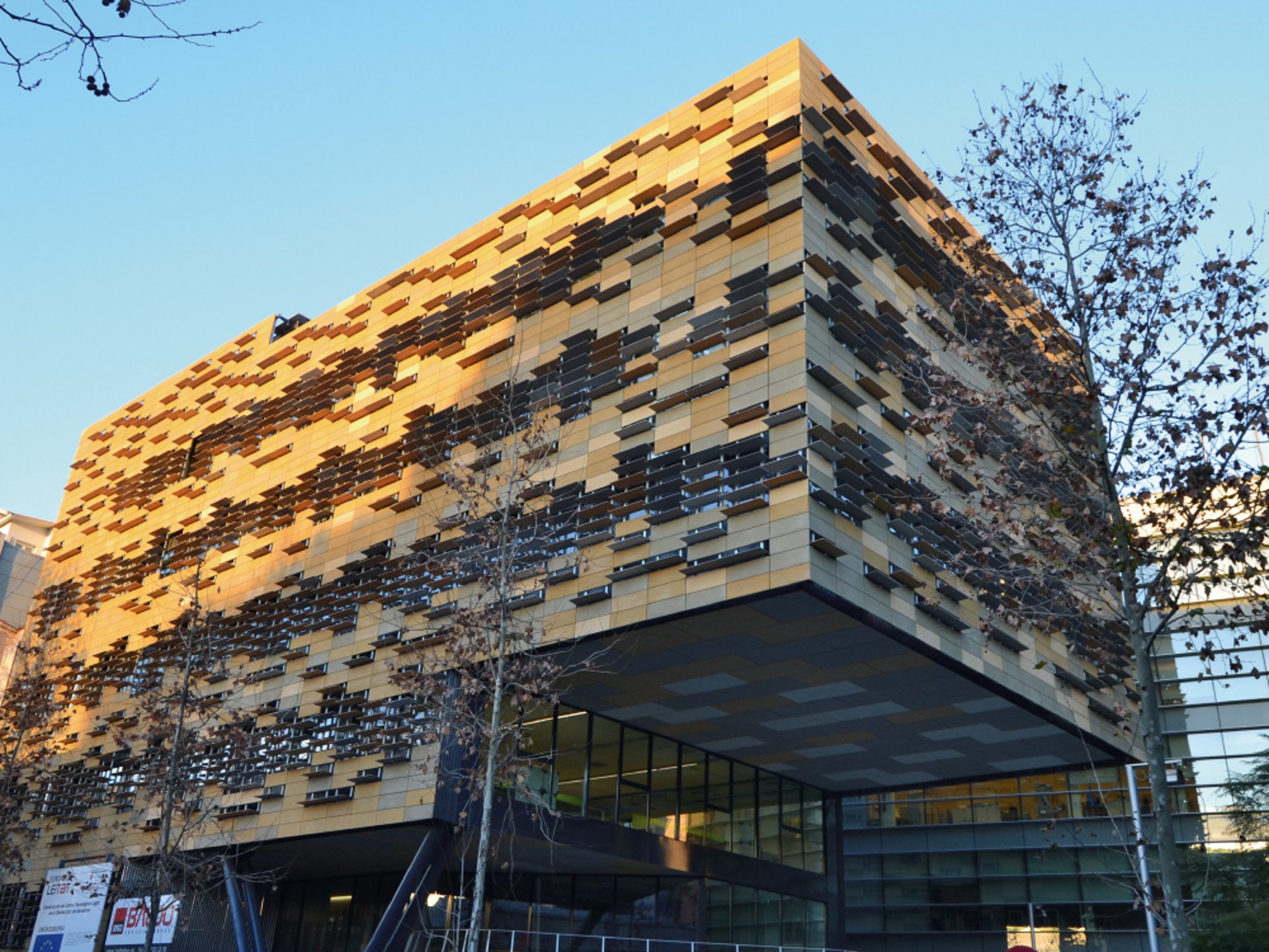 an abstract photo of a curved building with a blue sky in the background