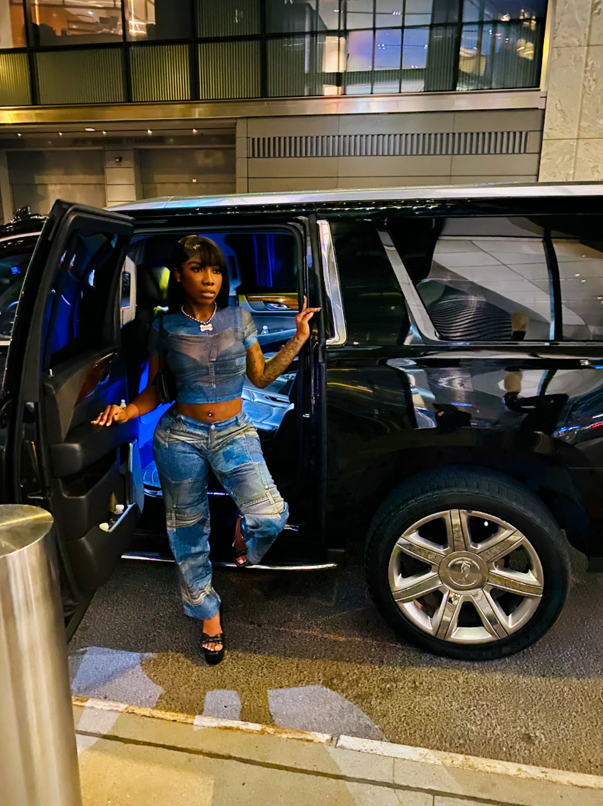 a black suv parked in a parking lot at night