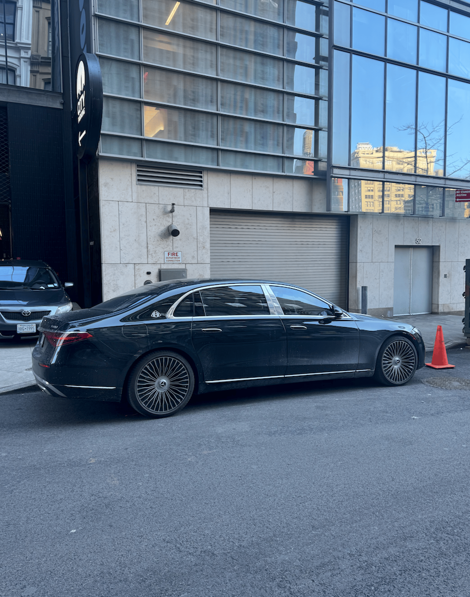 A black car parked on the side of the road