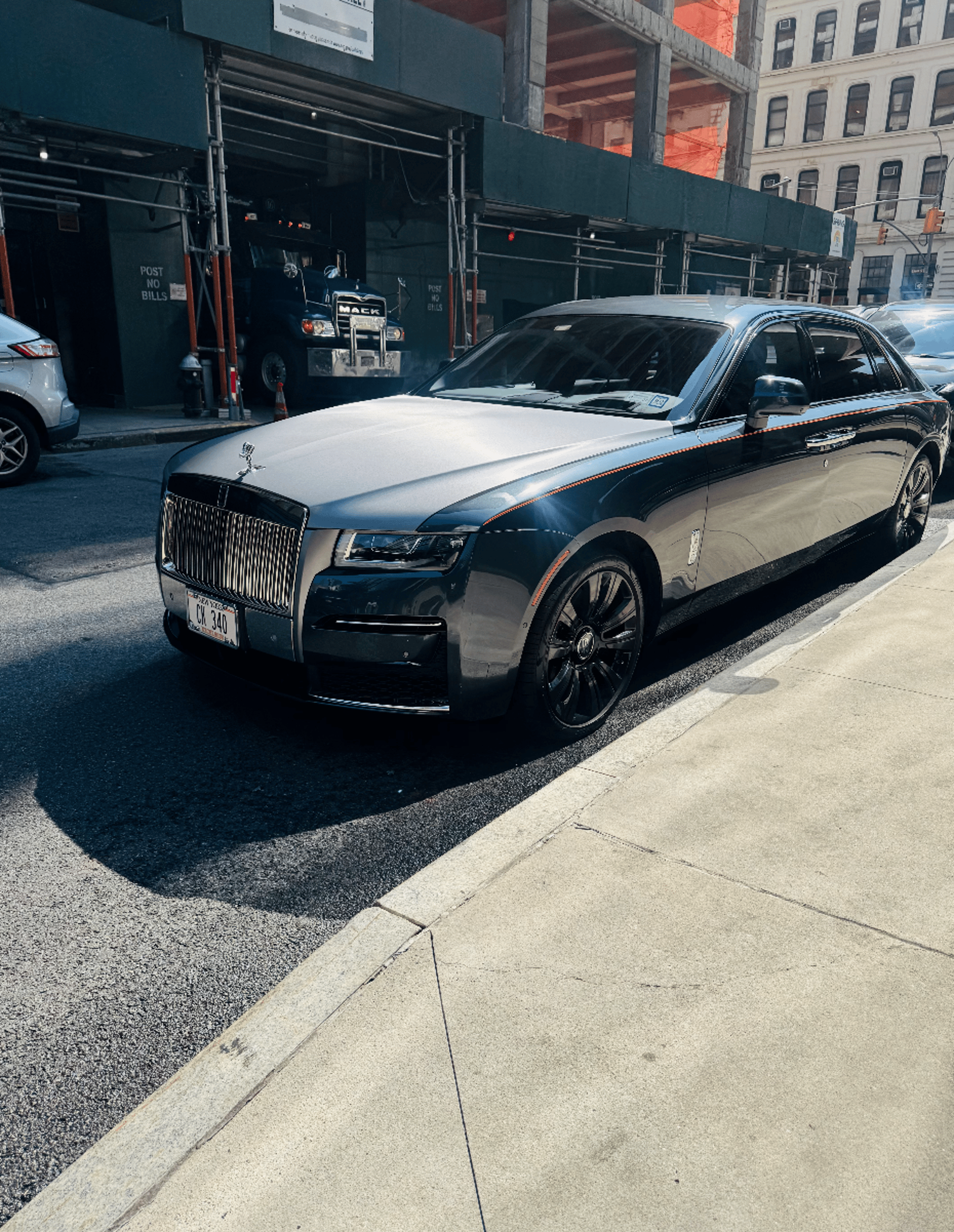 A black car parked on the side of the road