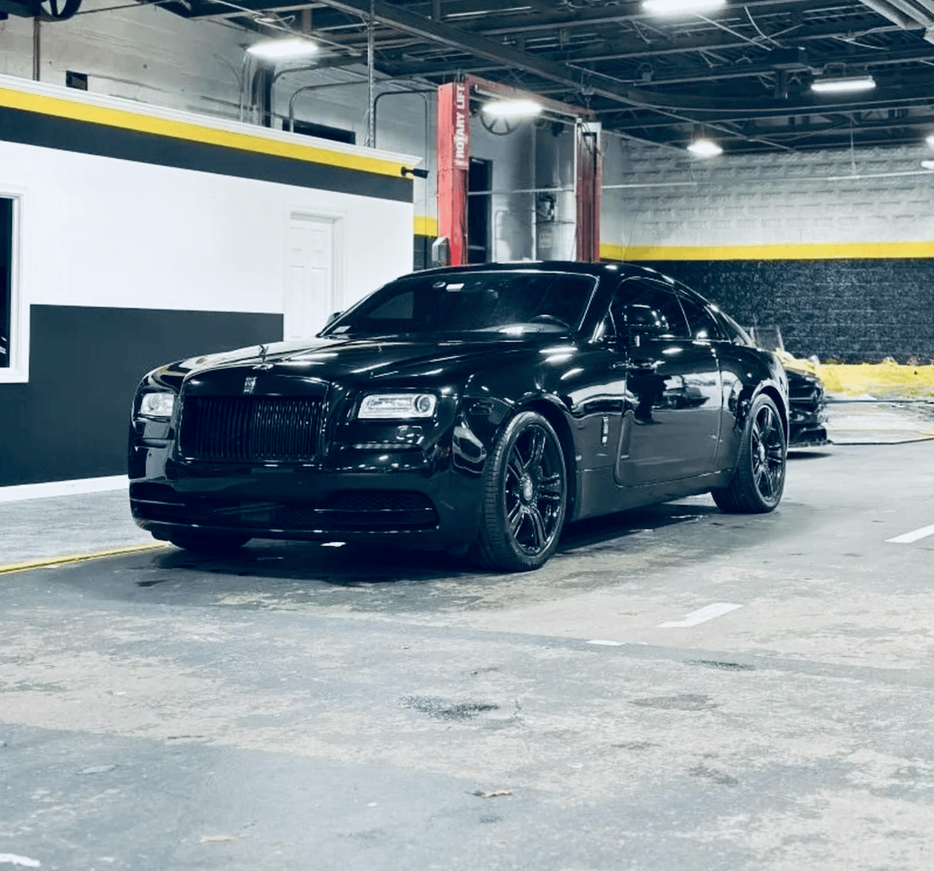 A black car parked on the side of the road