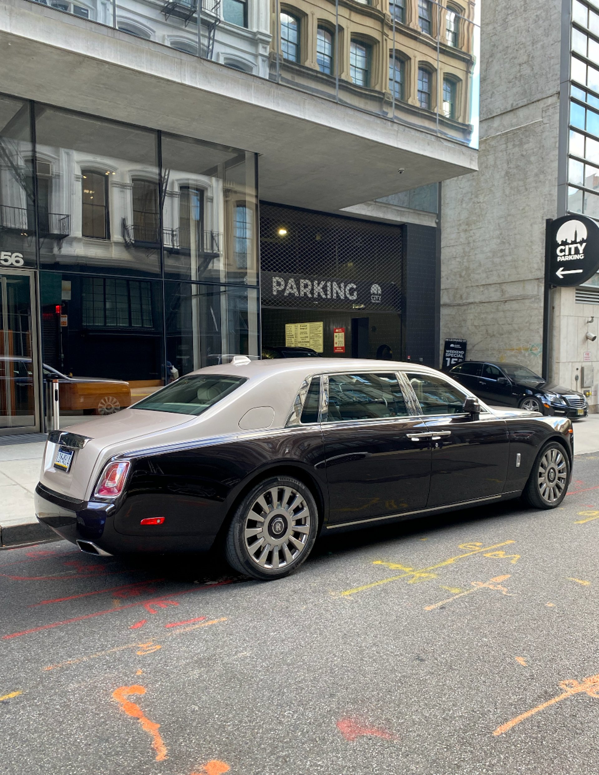 A black car parked on the side of the road
