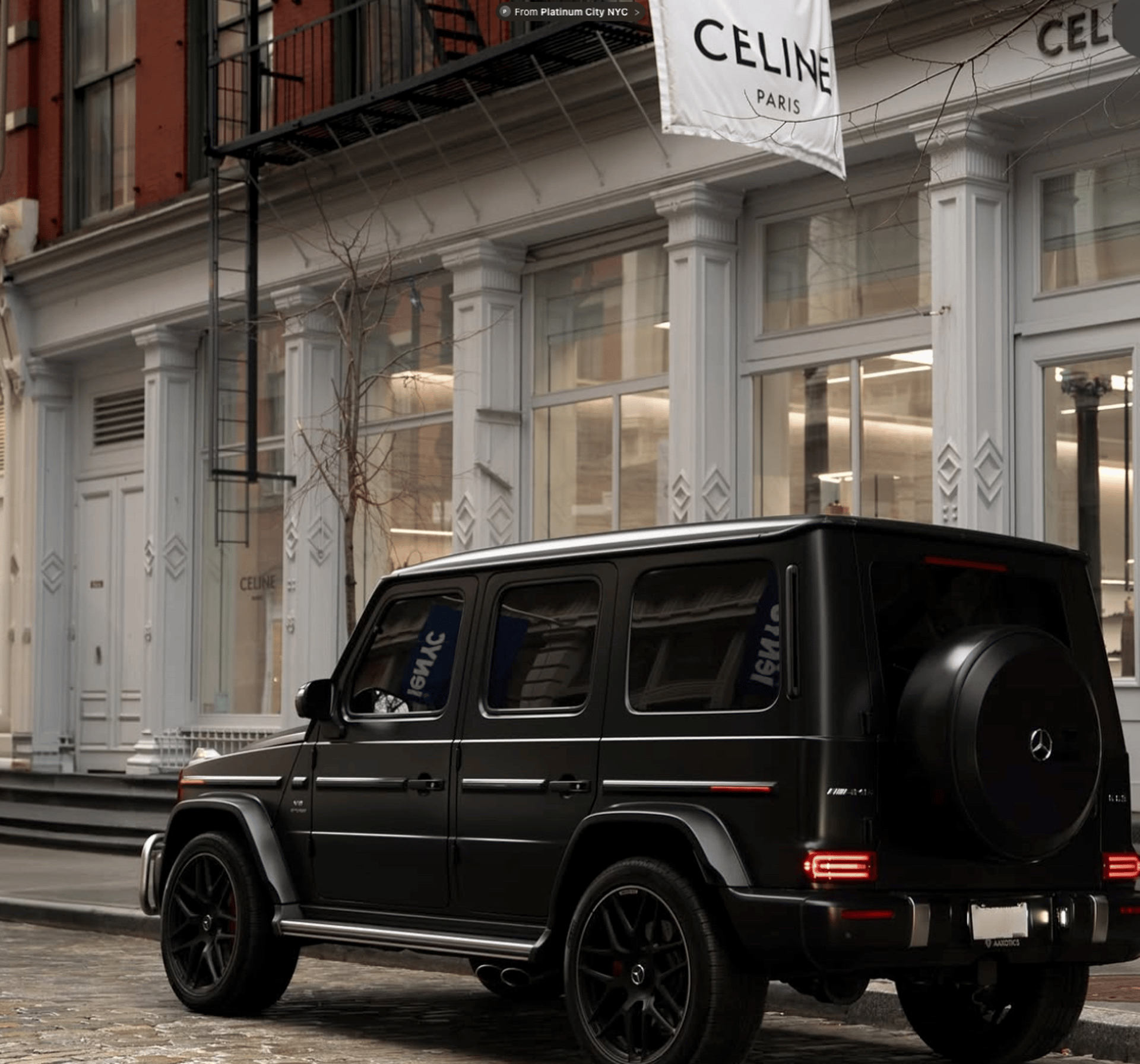 Luxury car with distinctive emblem and wheel detail.