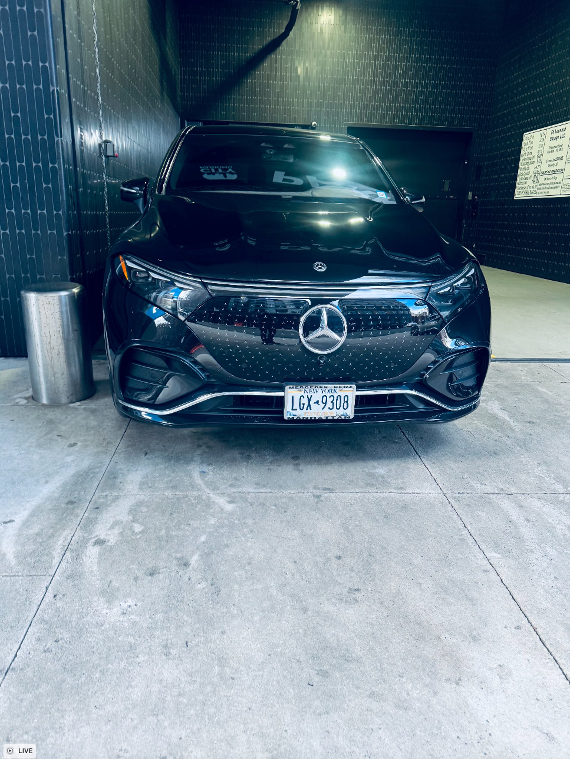 A black car parked on the side of the road