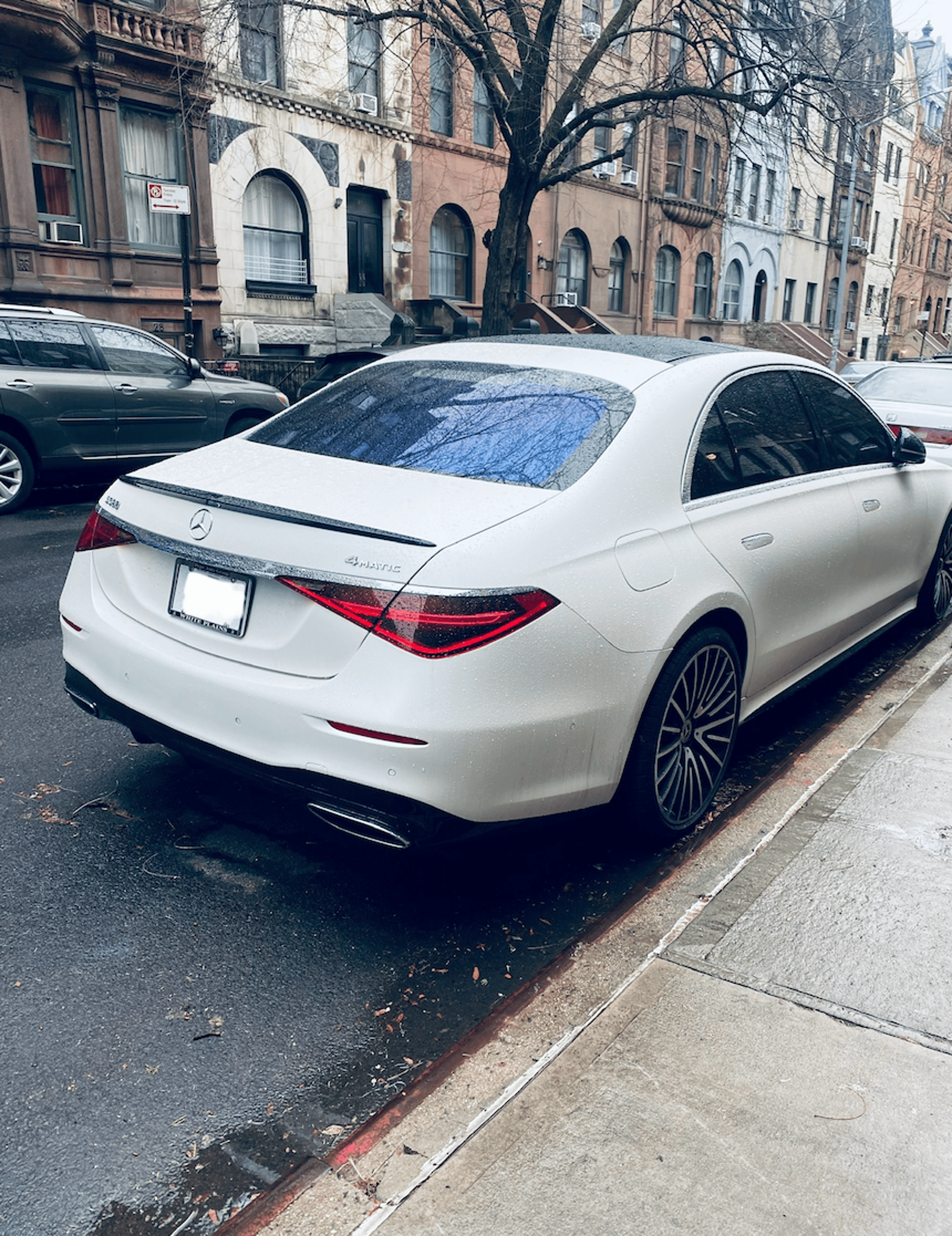 A black car parked on the side of the road