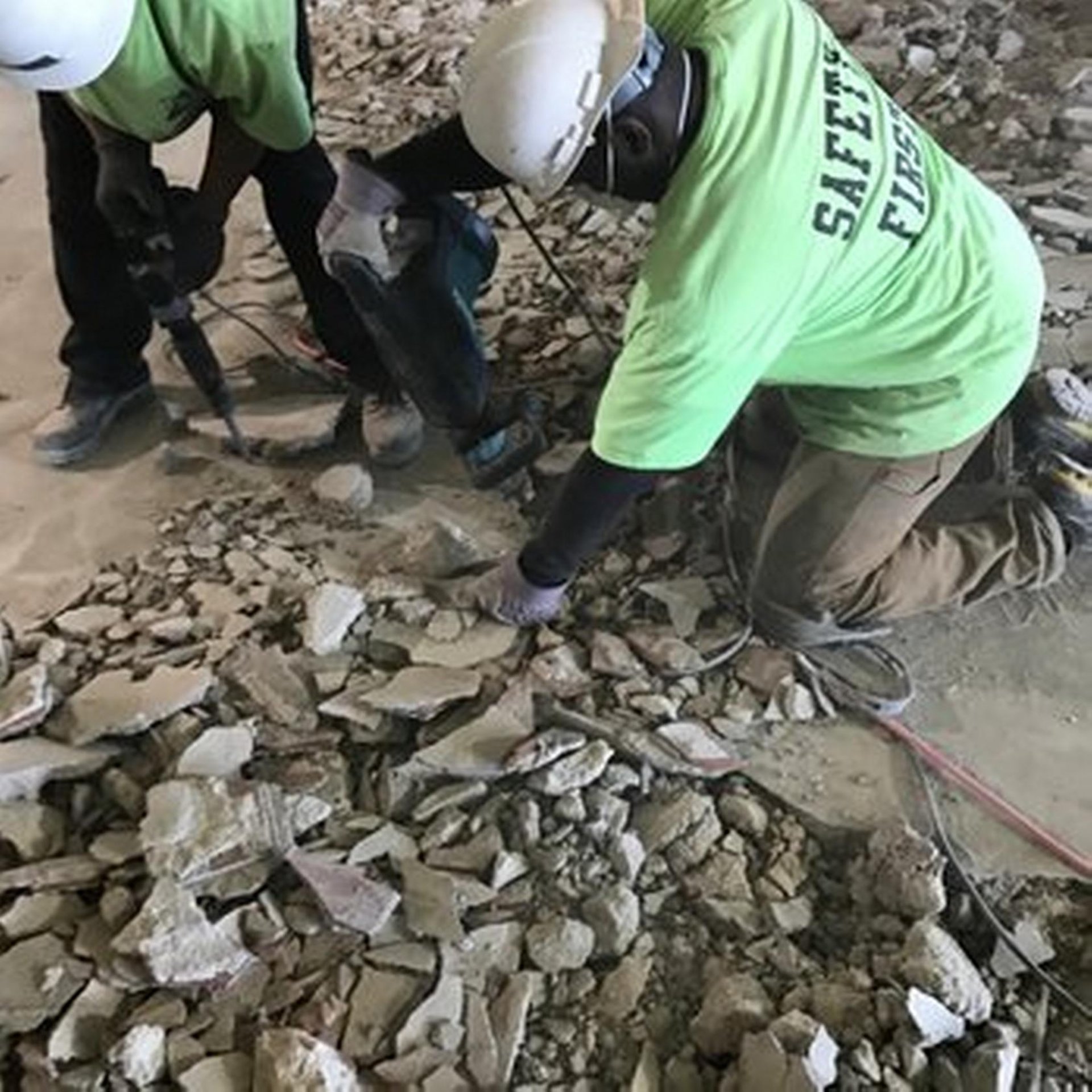 a man is shoveling through a construction site