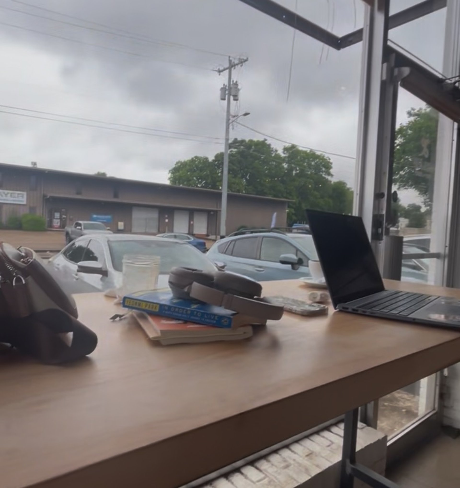 brown book on L-shape ruler beside pen