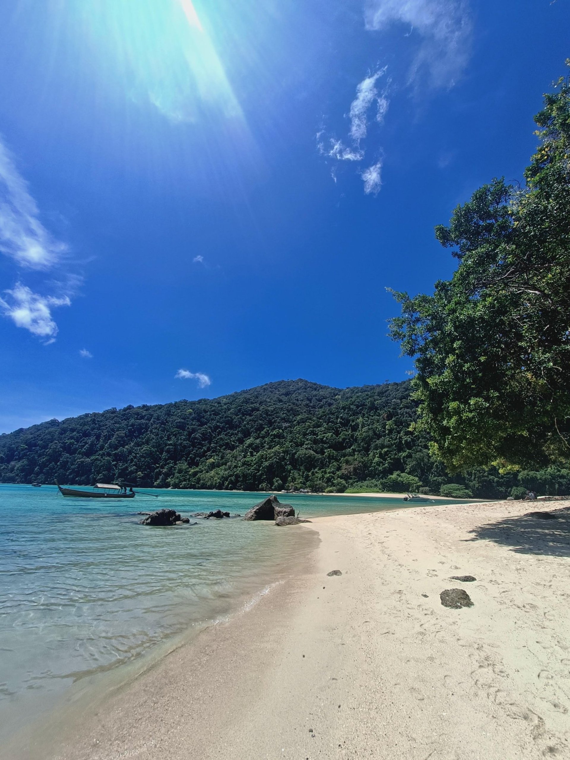 people riding on boat on beach during daytime