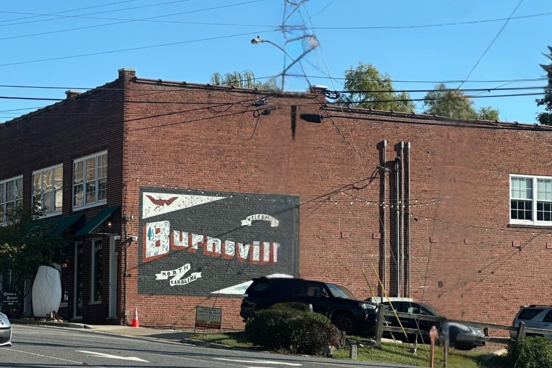 Downtown Burnsville brick building with 'Burnsville' mural, representing Jack's Locksmith commercial services in Western NC