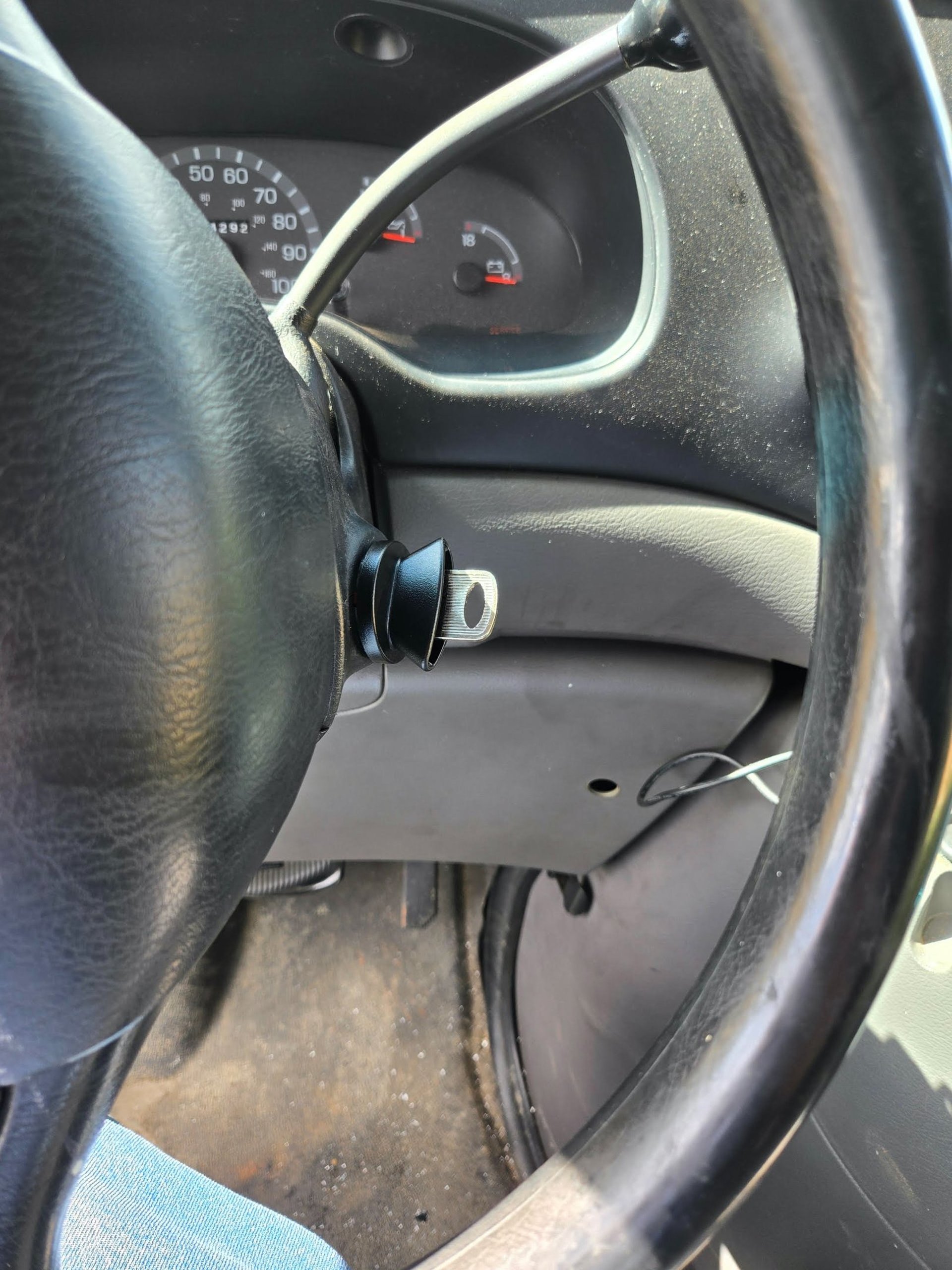 Car key I replacement inserted in the ignition near the steering wheel