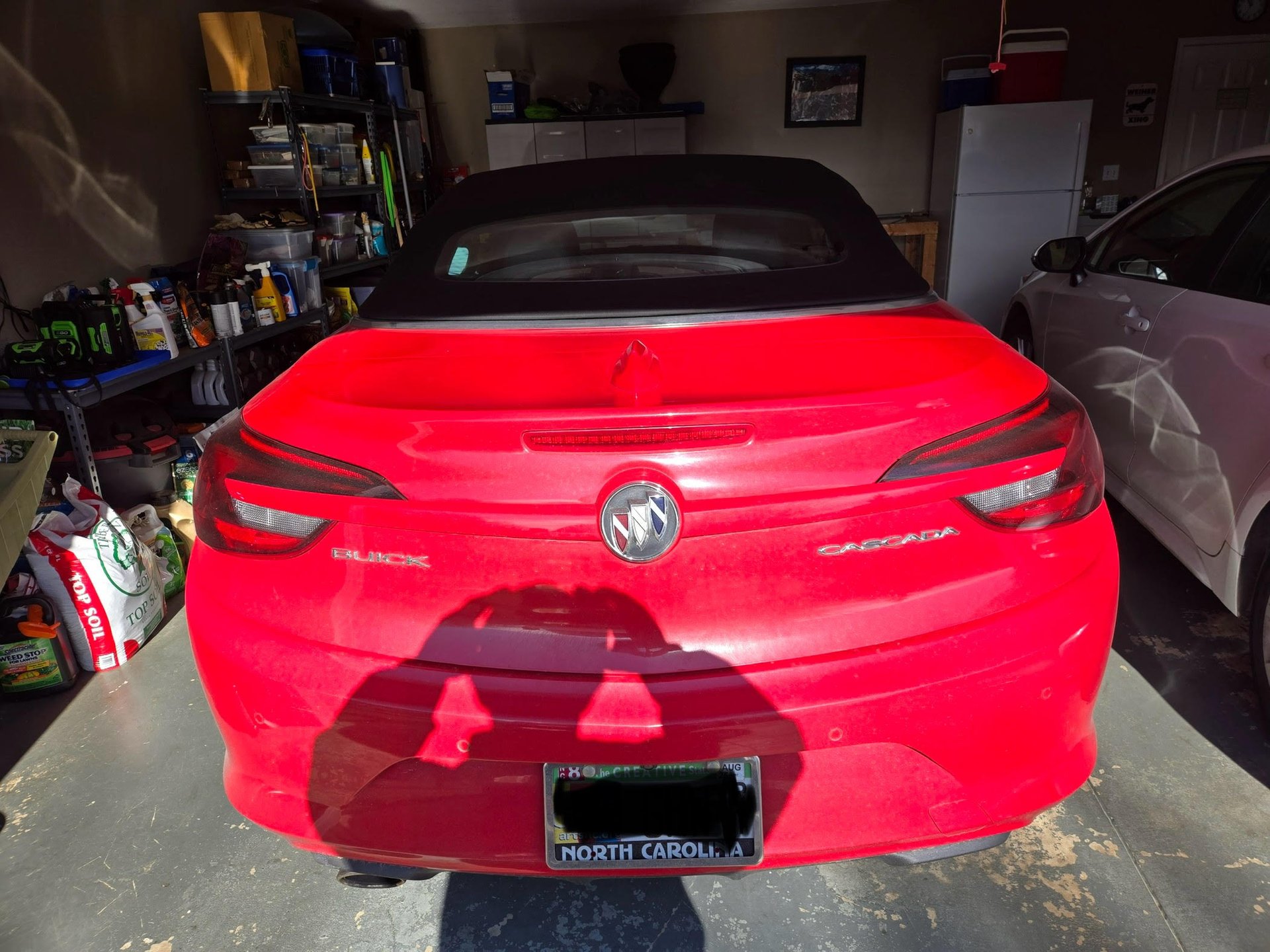 Red Buick Cascada parked in garage