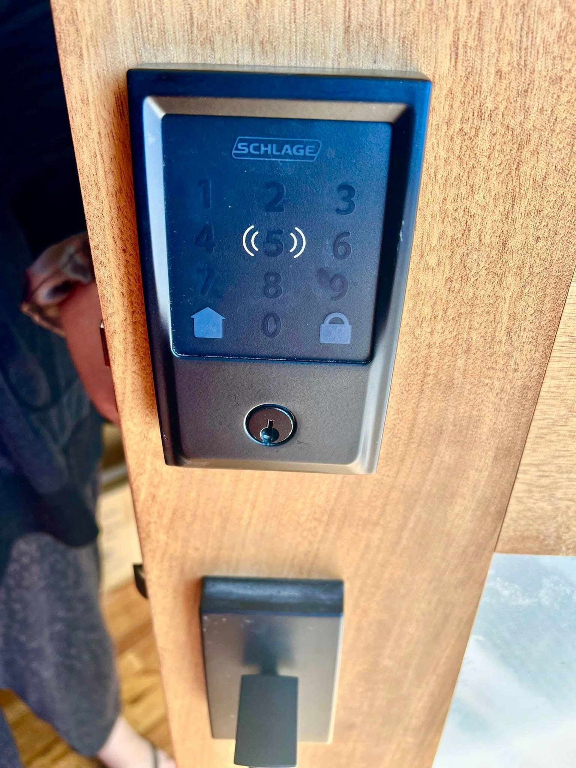 Schlage keypad smart lock installed on a wooden residential door