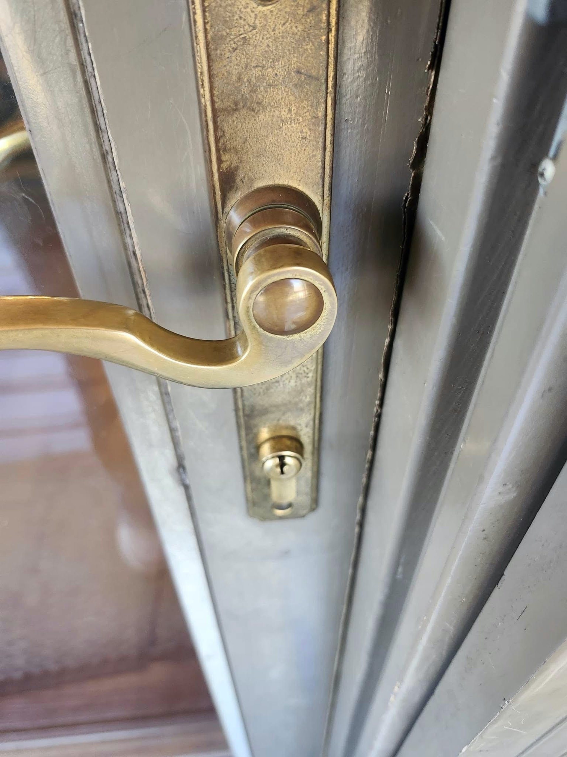 A close up of a gold doorknob on a residence door