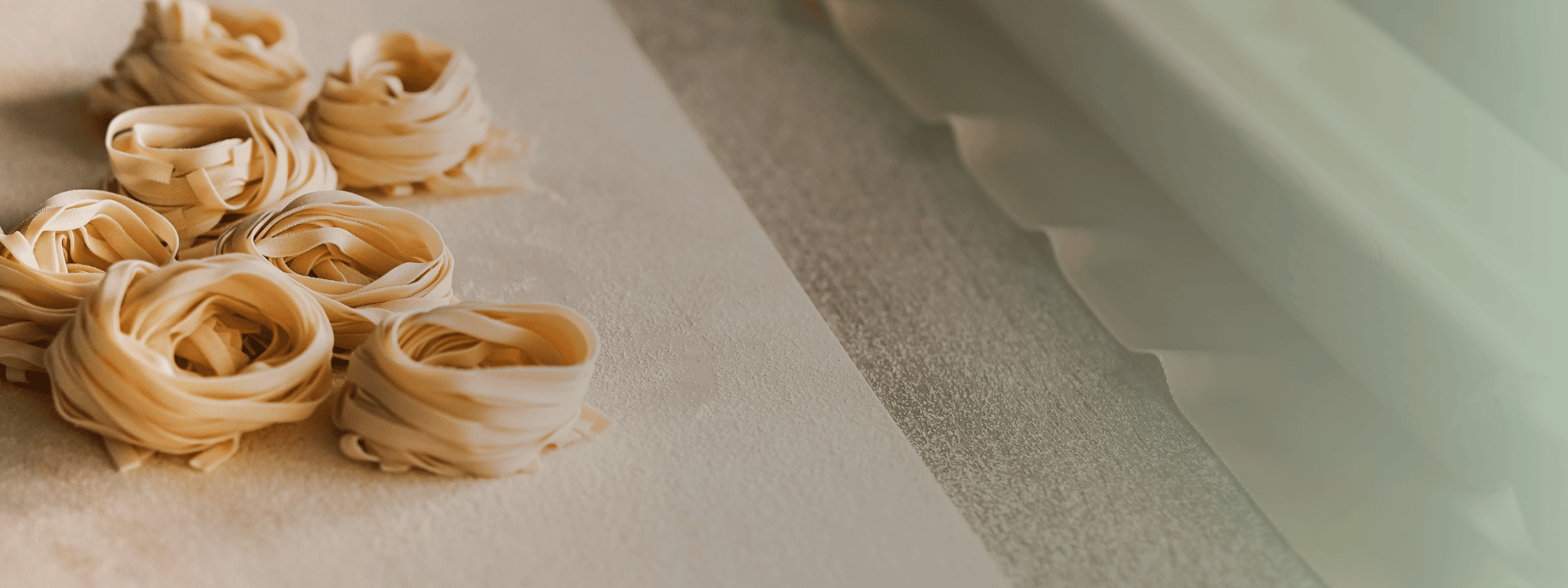 person holding white ceramic bowl with pasta