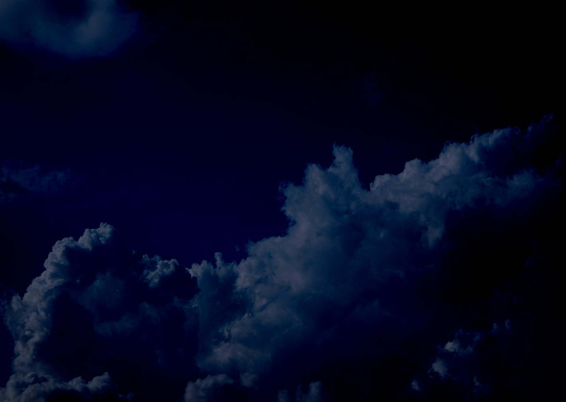 a plane flying in the sky with a lot of clouds
