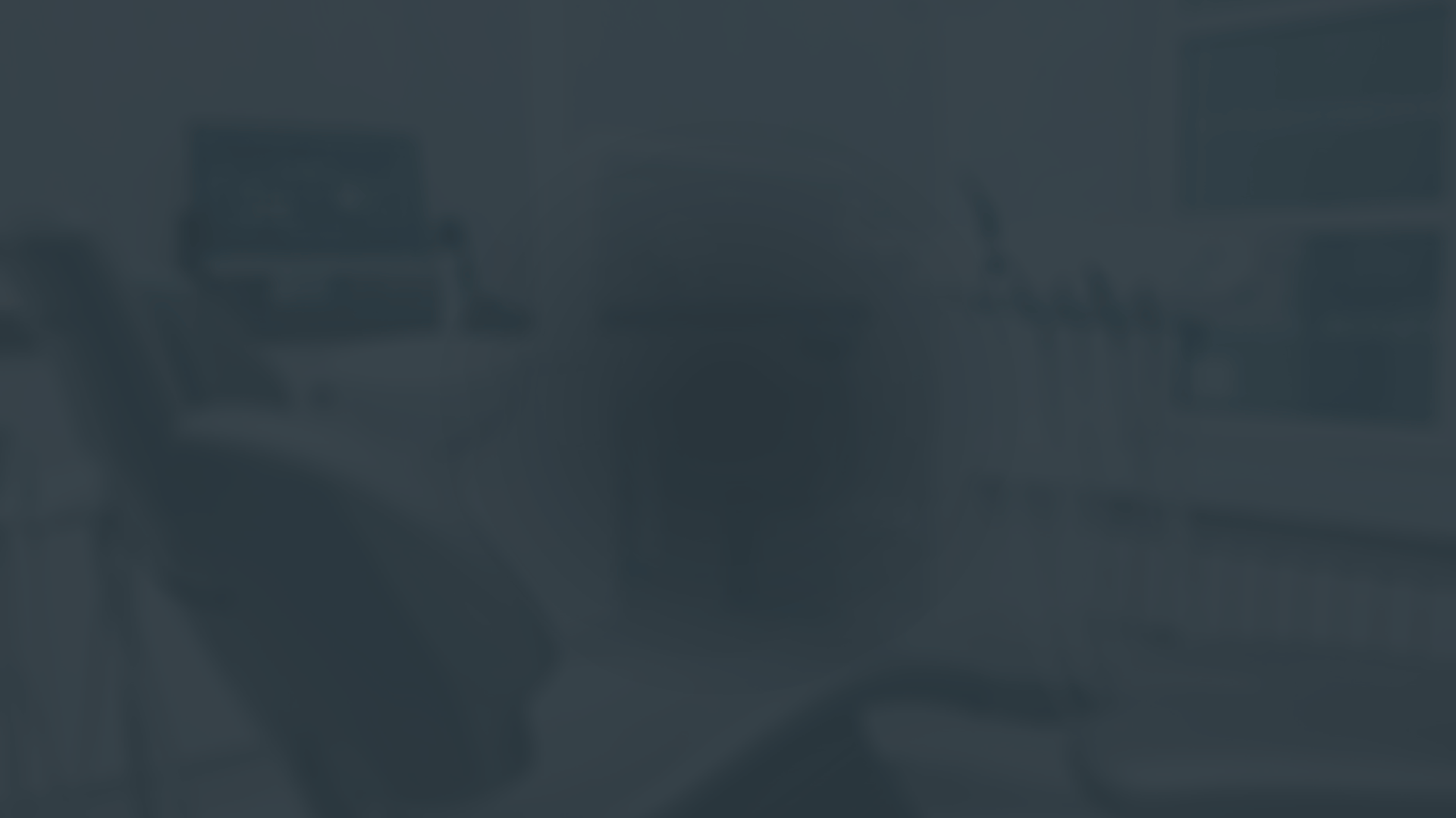 an abstract photo of a curved building with a blue sky in the background