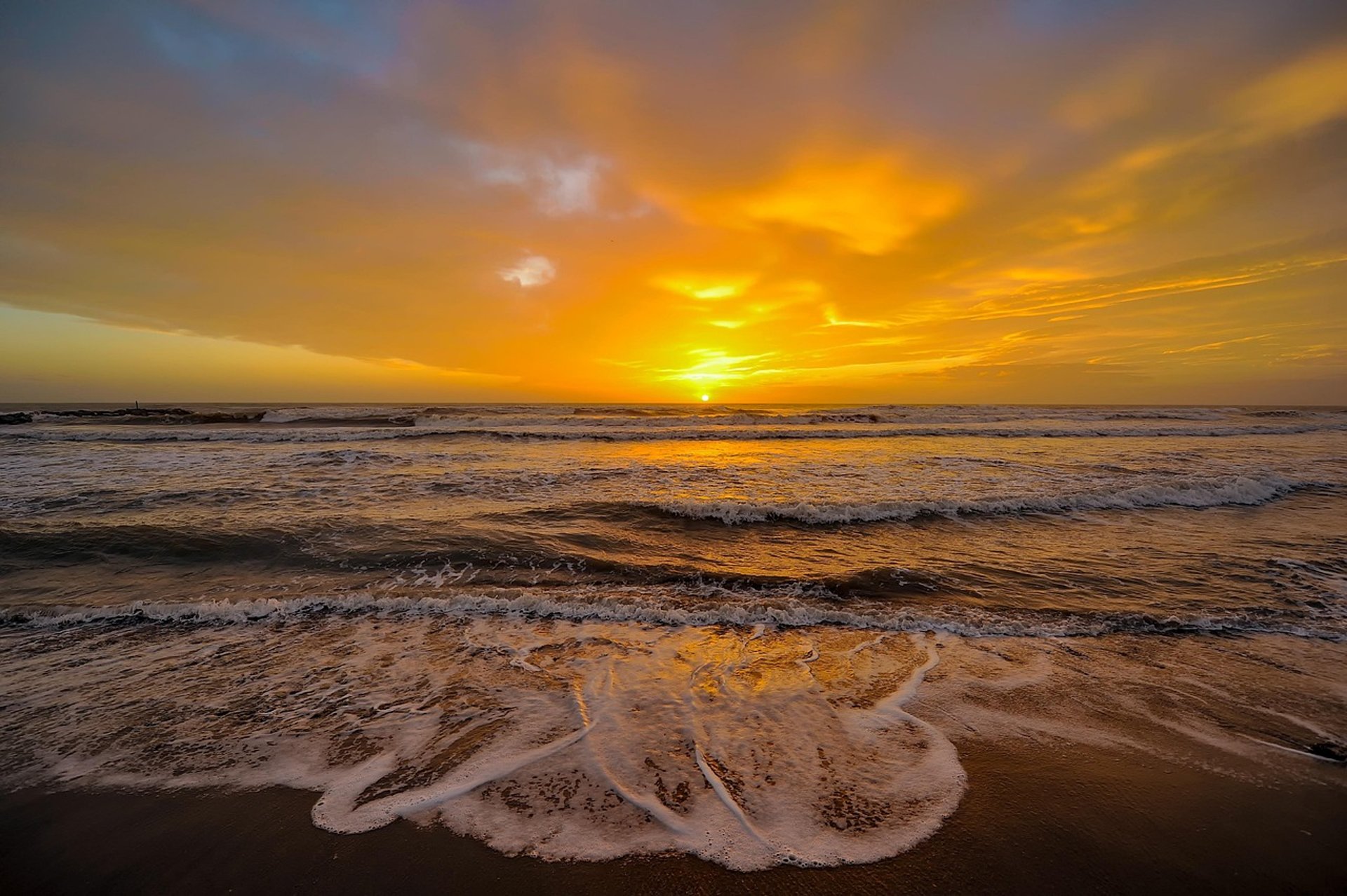 brown wooden fence on beach during sunset