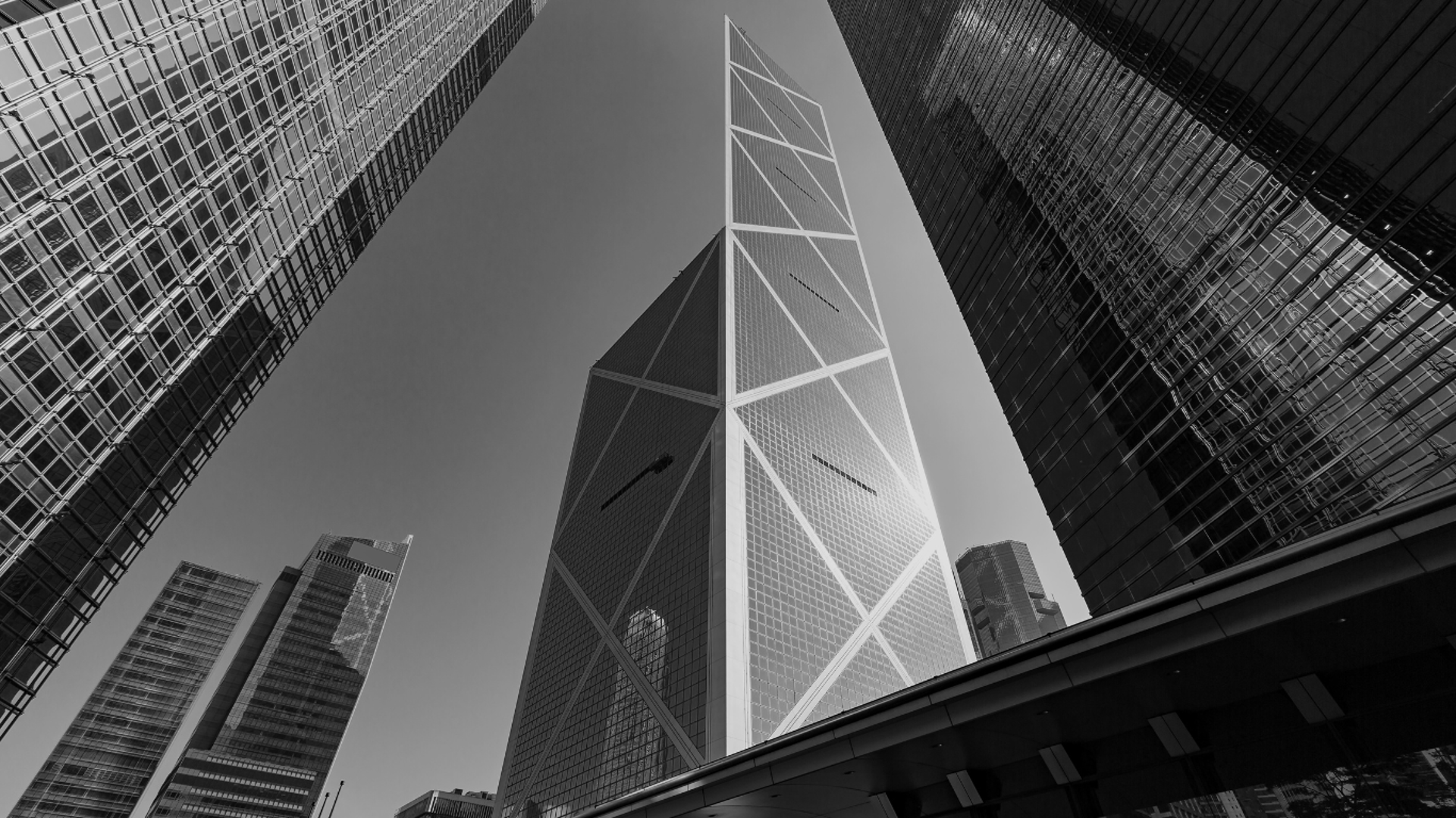 an abstract photo of a curved building with a blue sky in the background