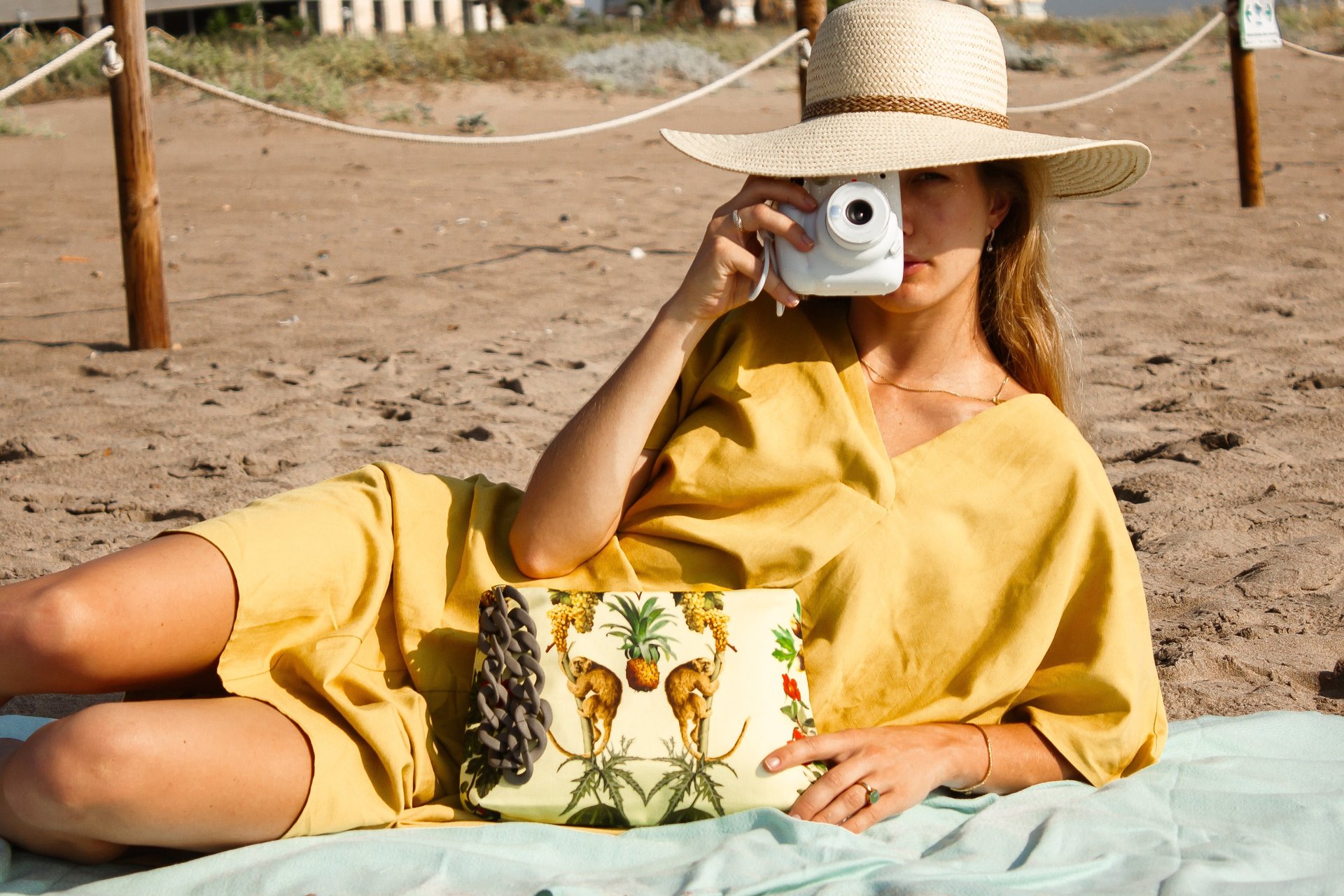 woman wearing yellow long-sleeved dress under white clouds and blue sky during daytime
