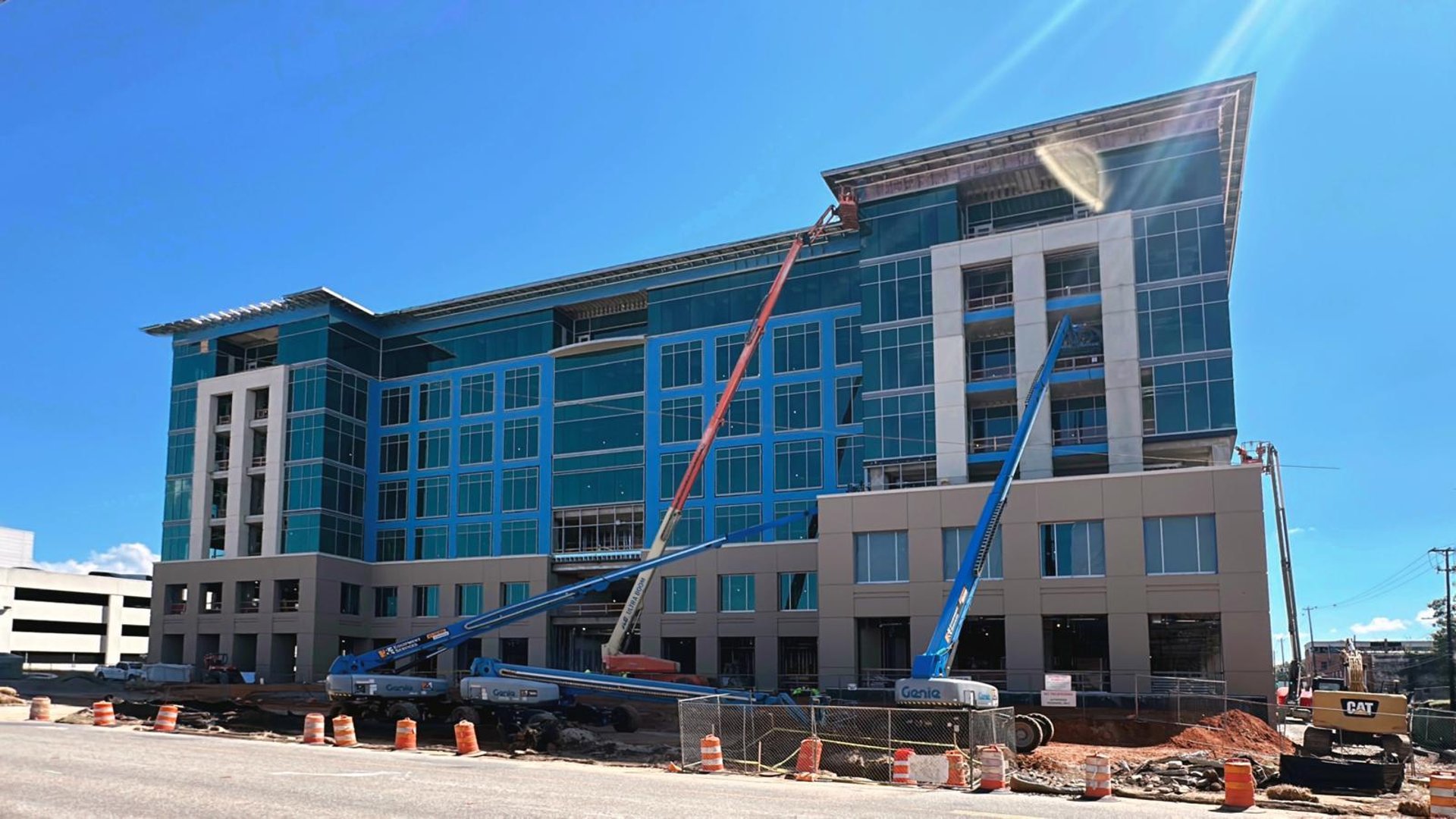 an abstract photo of a curved building with a blue sky in the background