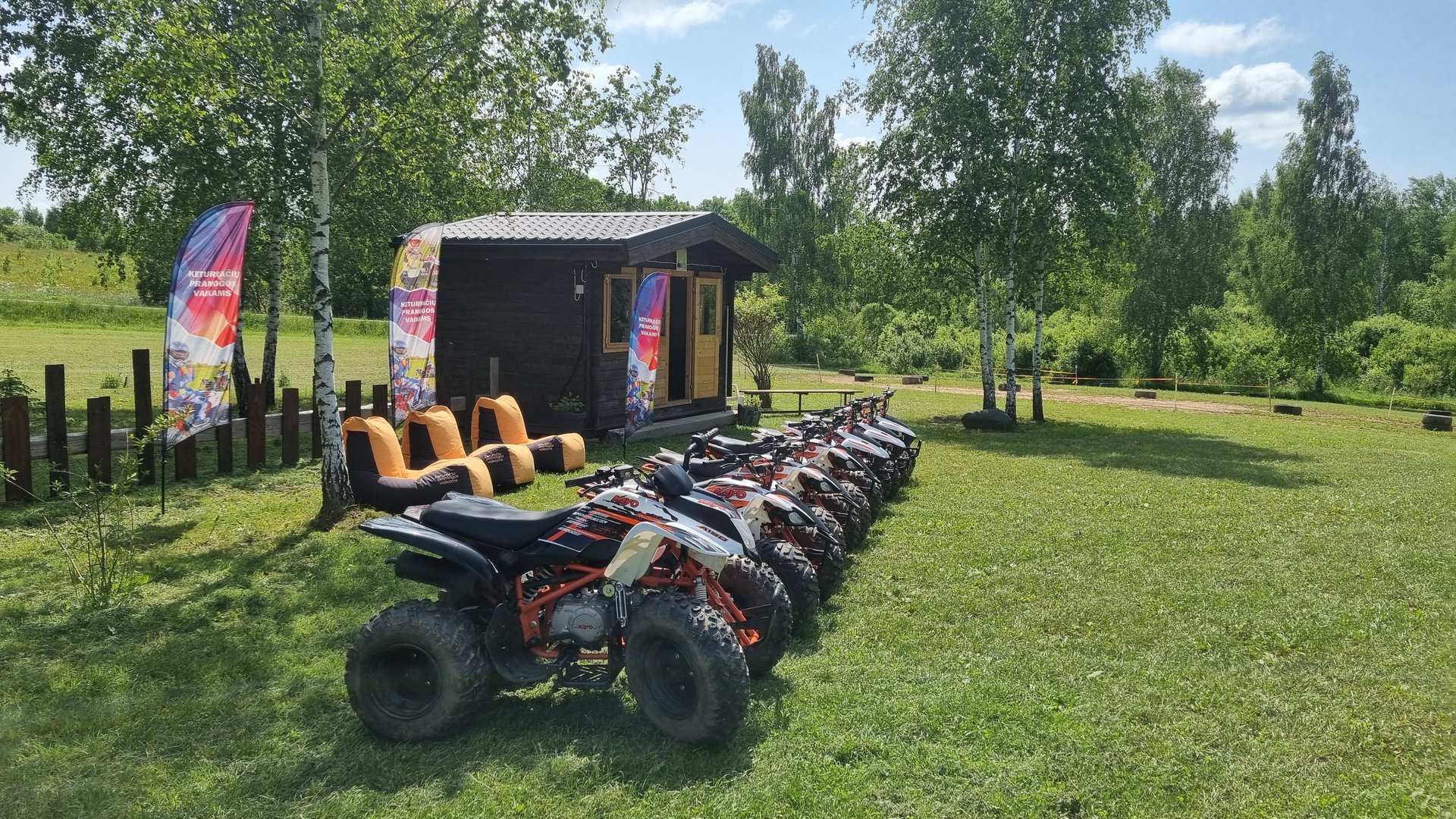 man in blue jacket riding yellow atv