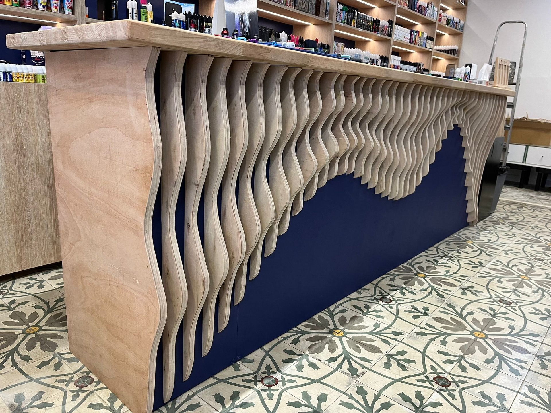 an abstract photo of a curved building with a blue sky in the background