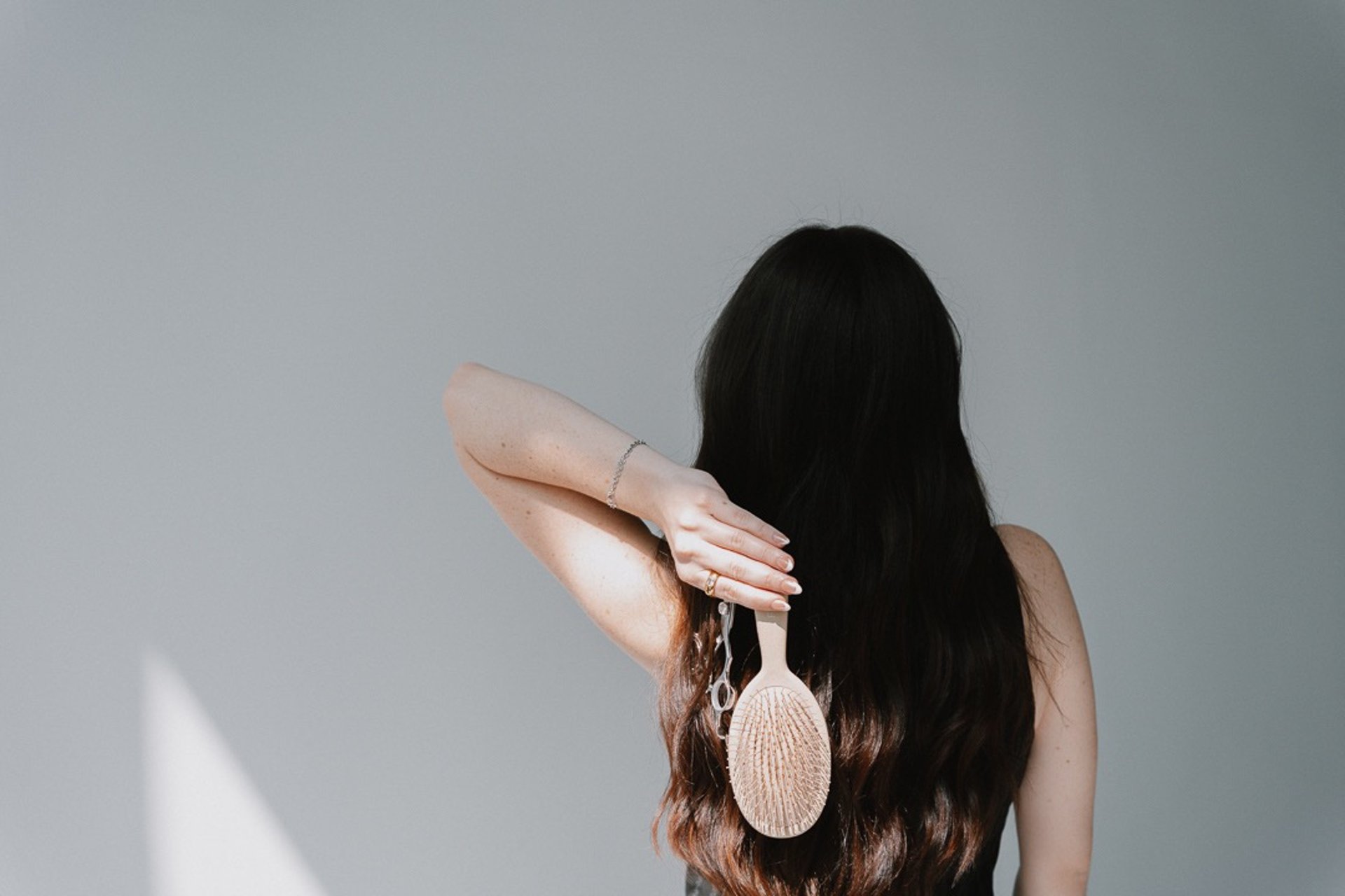 clear glass fragrance bottle beside gold-colored watch