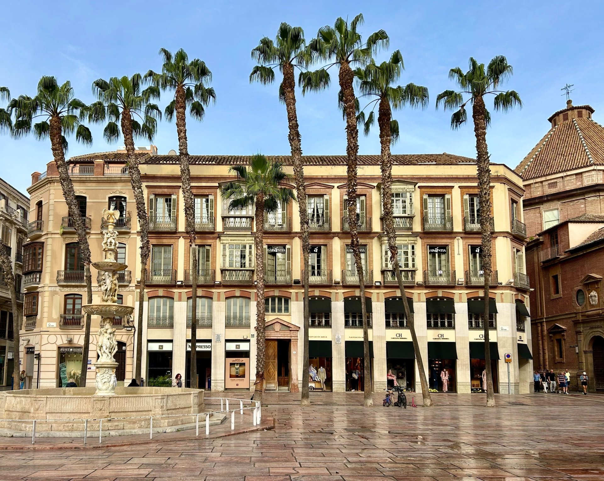 a street with palm trees and buildings