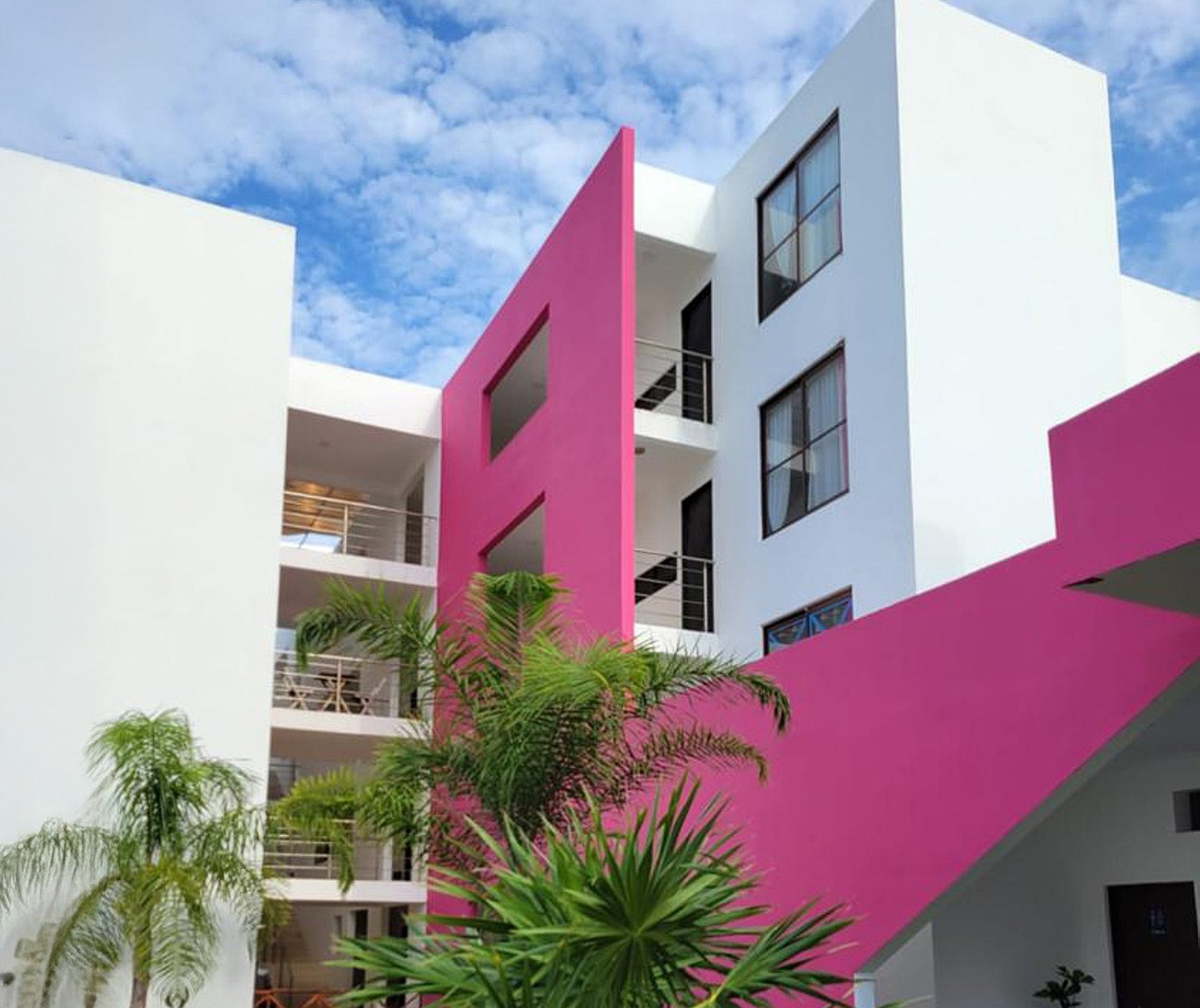 an abstract photo of a curved building with a blue sky in the background