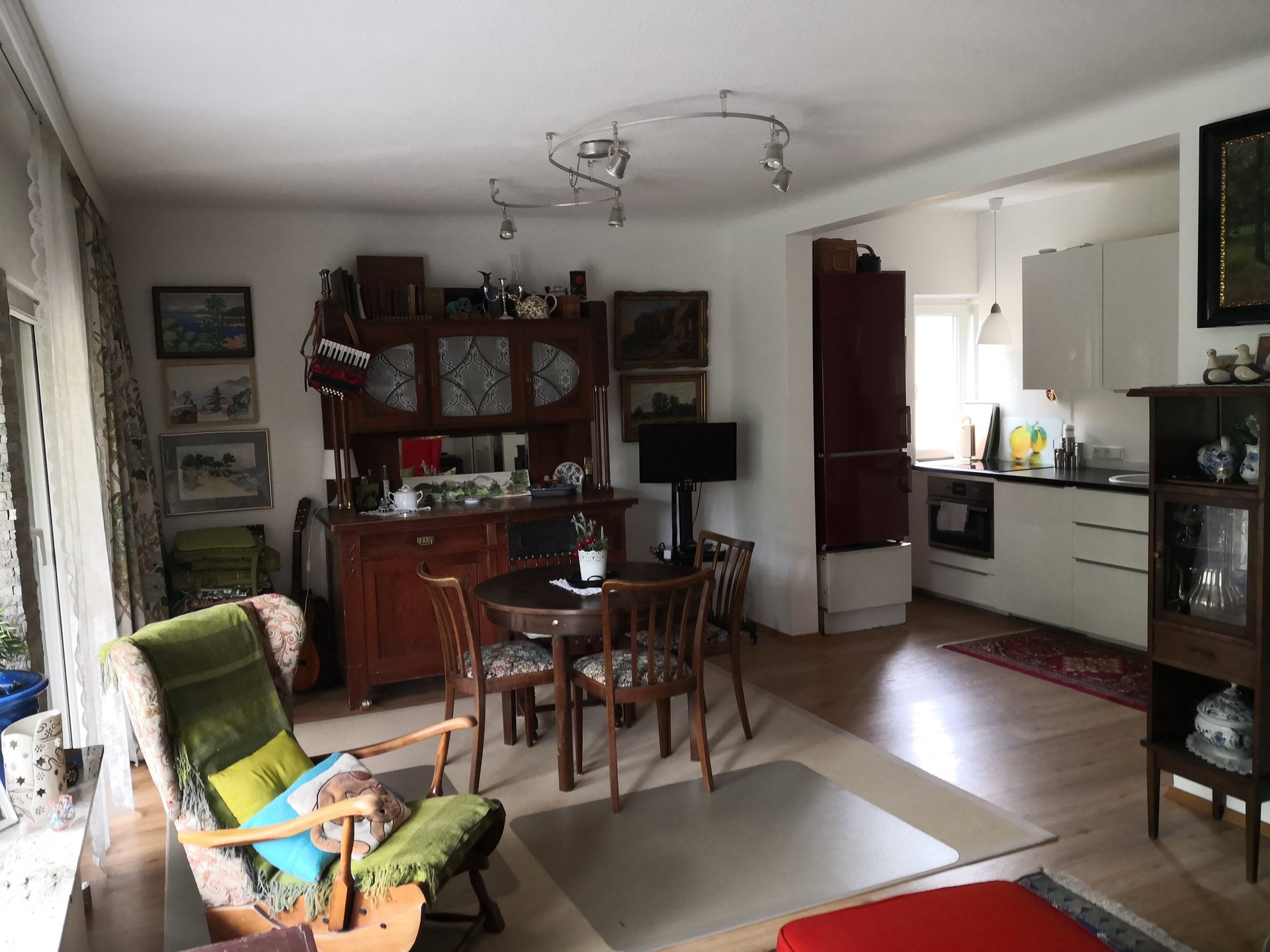 white and brown concrete building near green grass field and body of water under blue sky