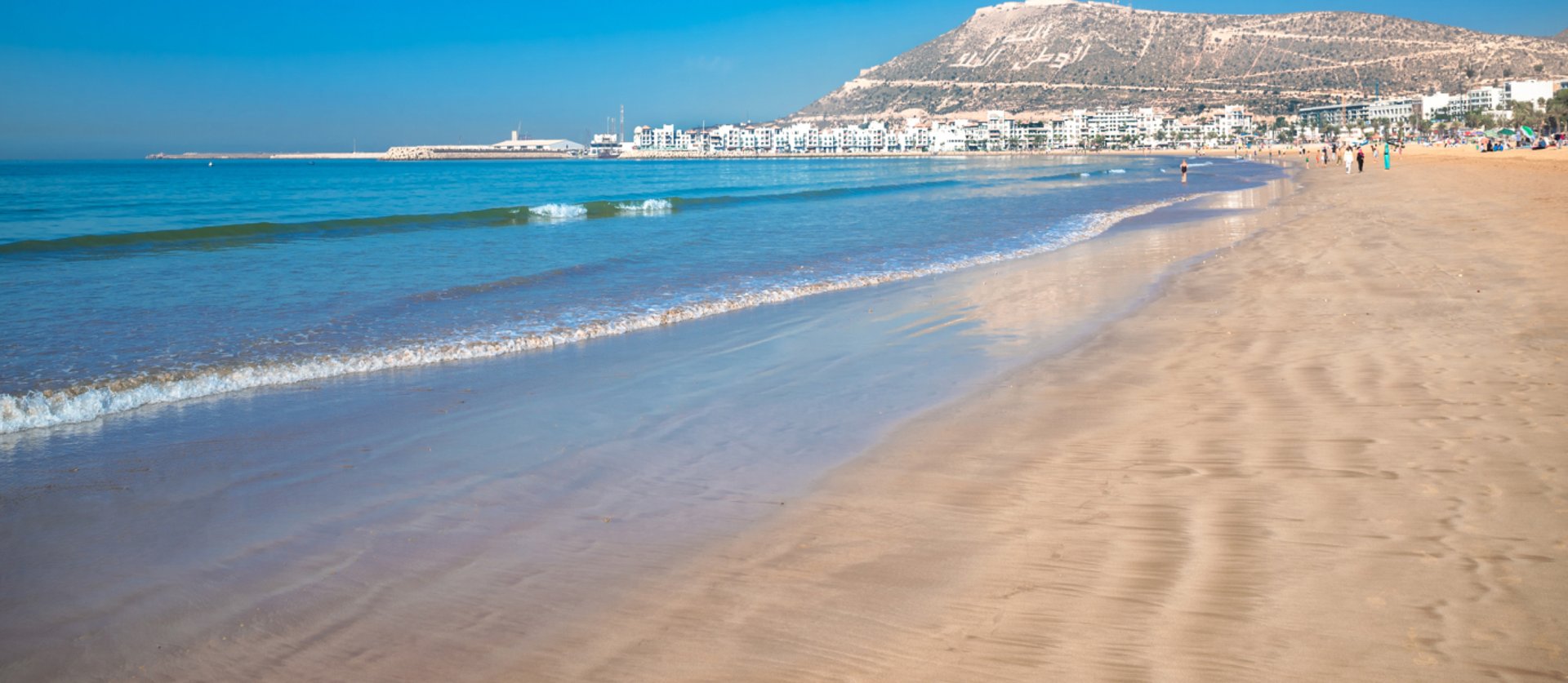 two person standing on shore