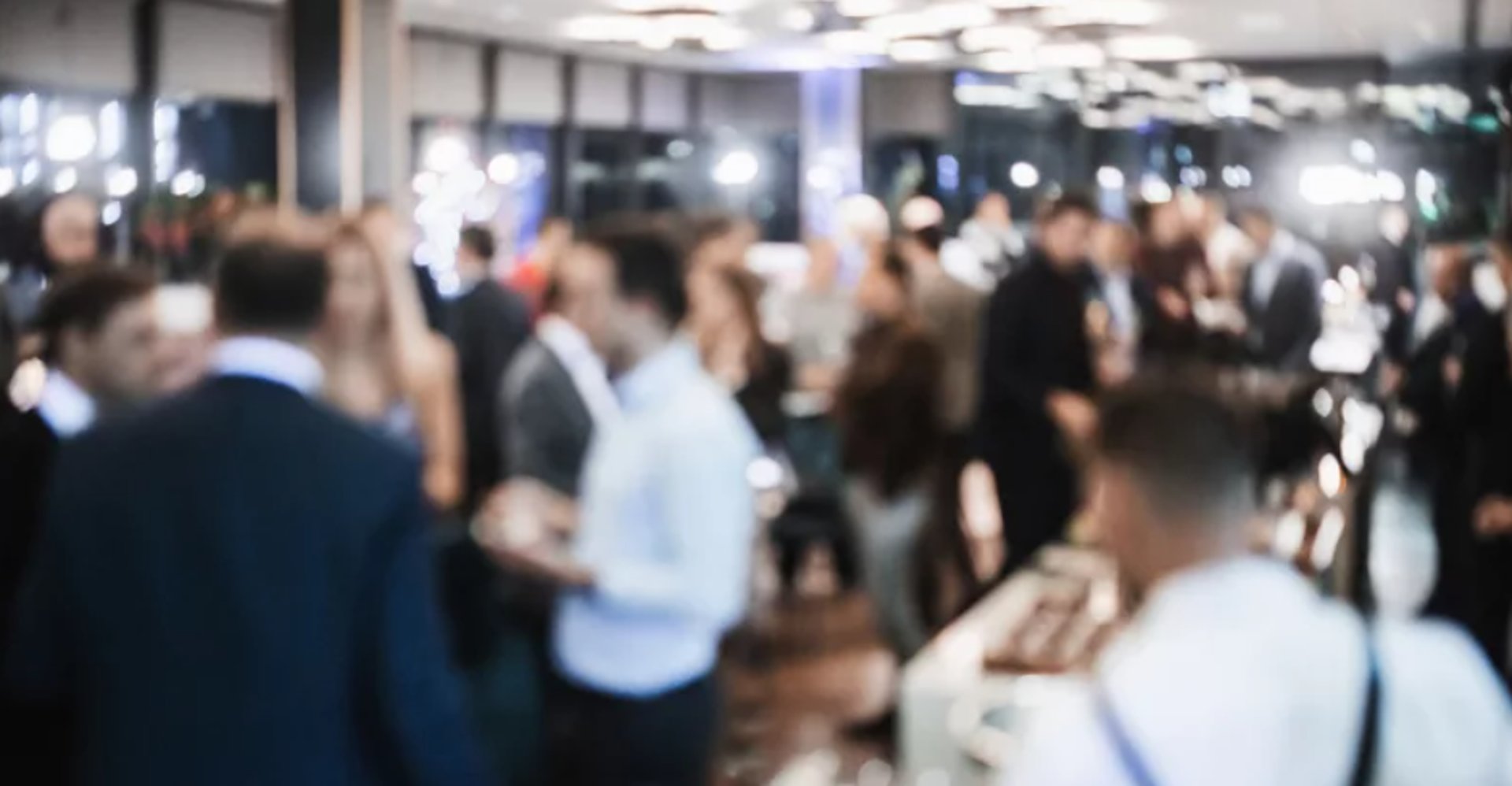 crowd of people sitting on chairs inside room