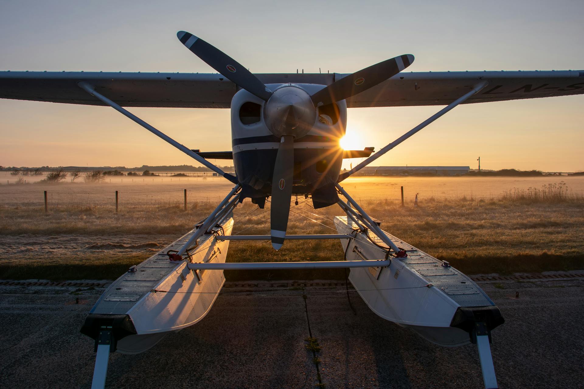 Seaplane parked at airport during sunrise or sunset. Cessna.