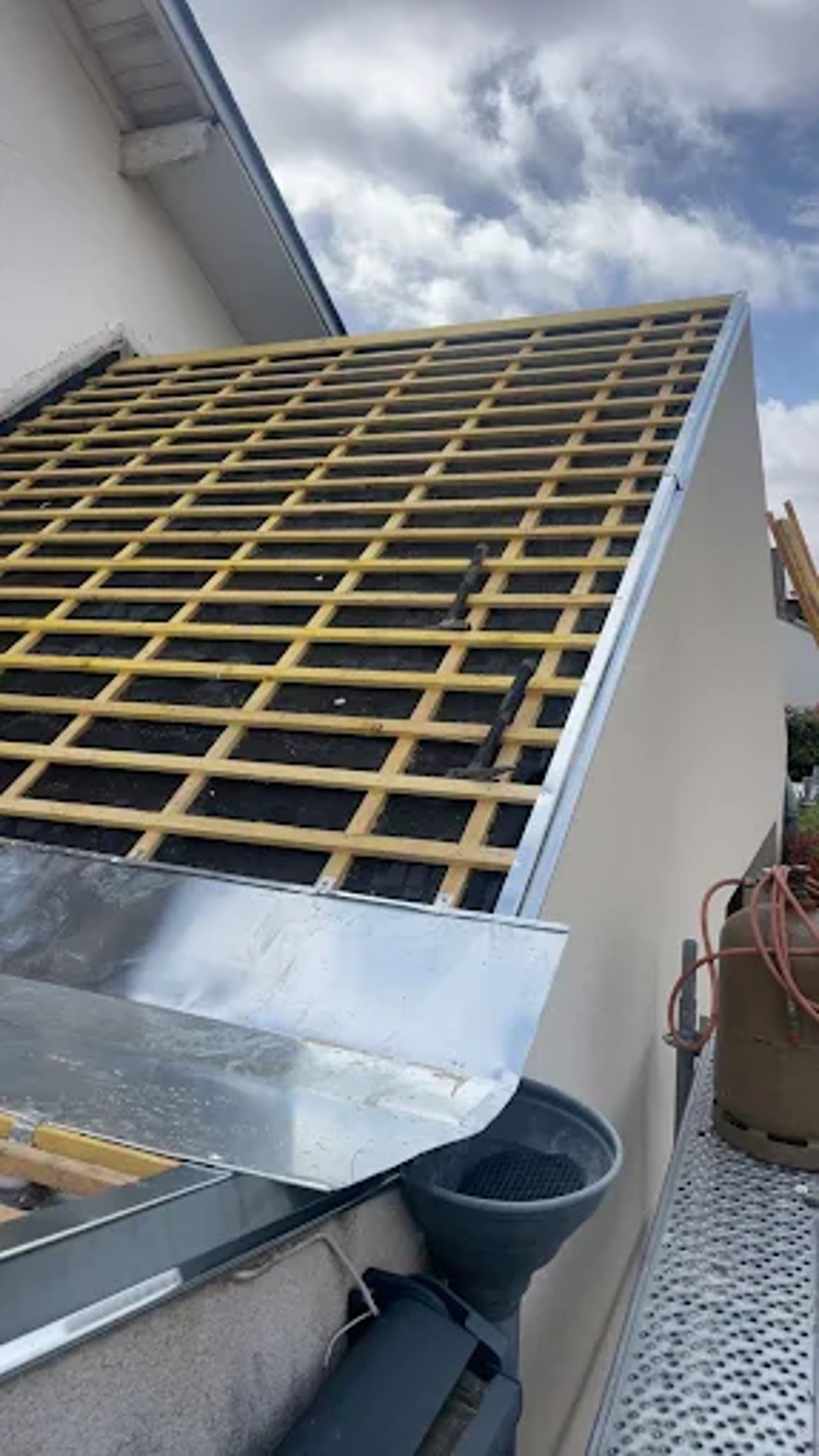 person in blue pants sitting on brown wooden floor