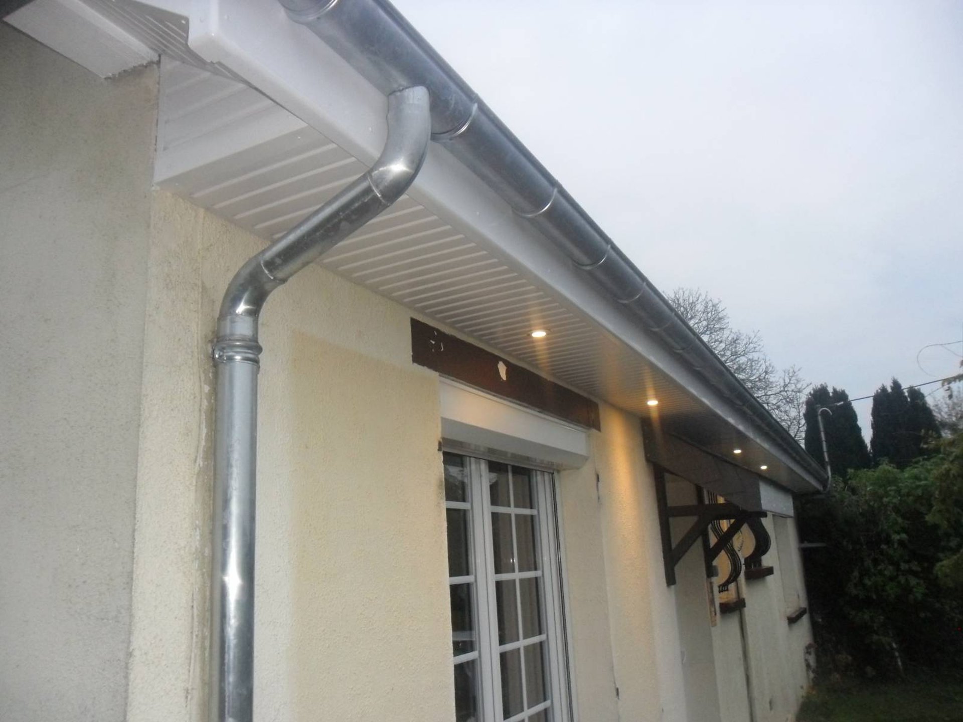 person in blue pants sitting on brown wooden floor