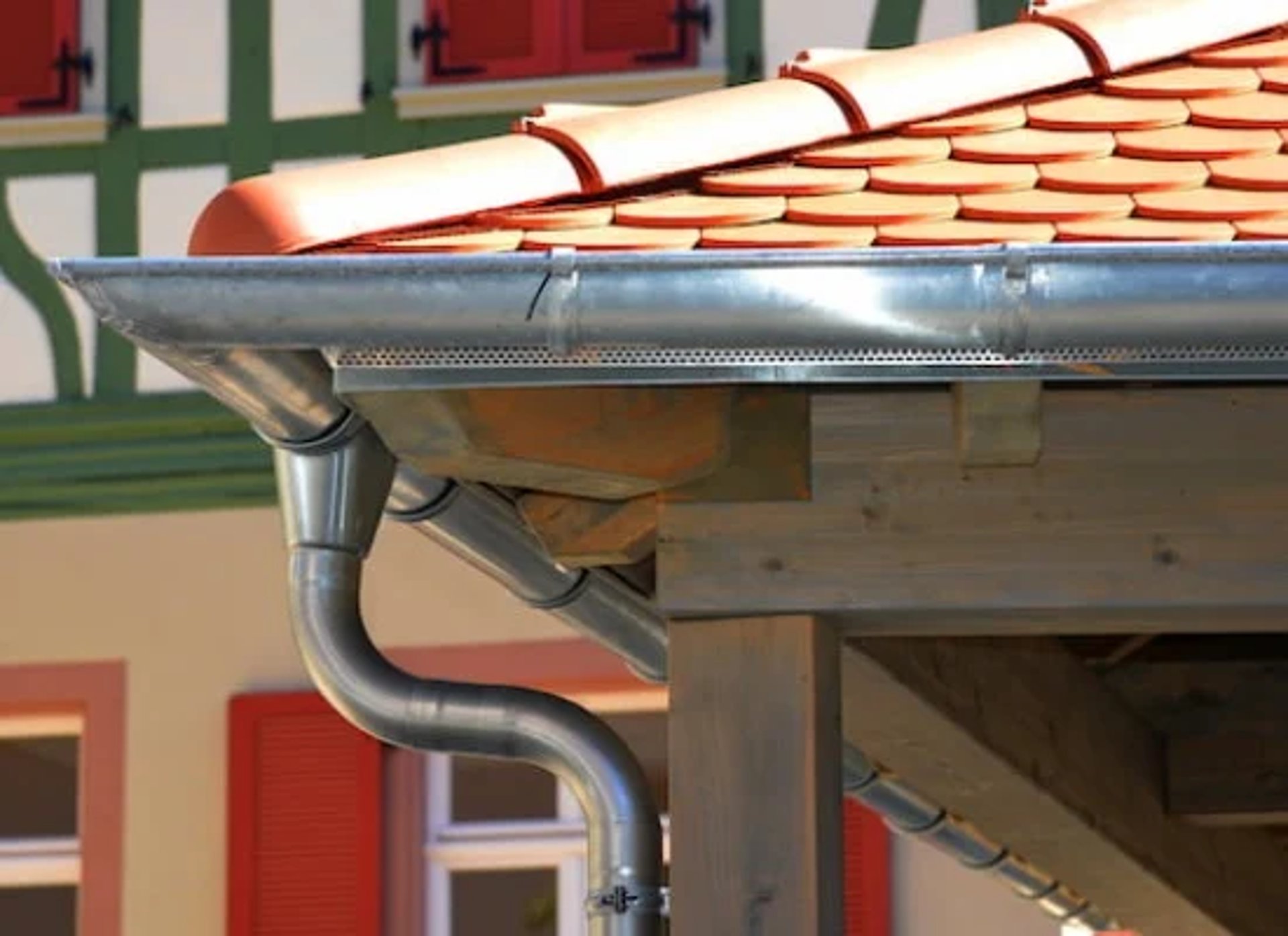 person in blue pants sitting on brown wooden floor