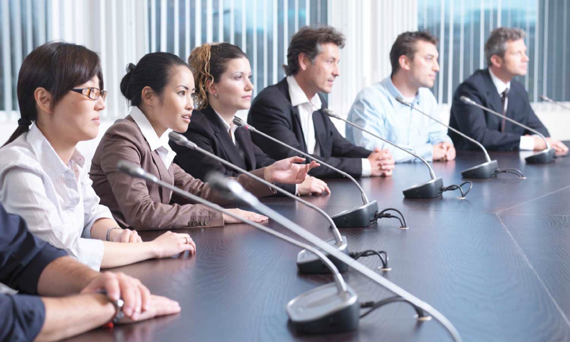 Business meeting with conference microphone systems for clear audio communication during hybrid discussions in Dubai