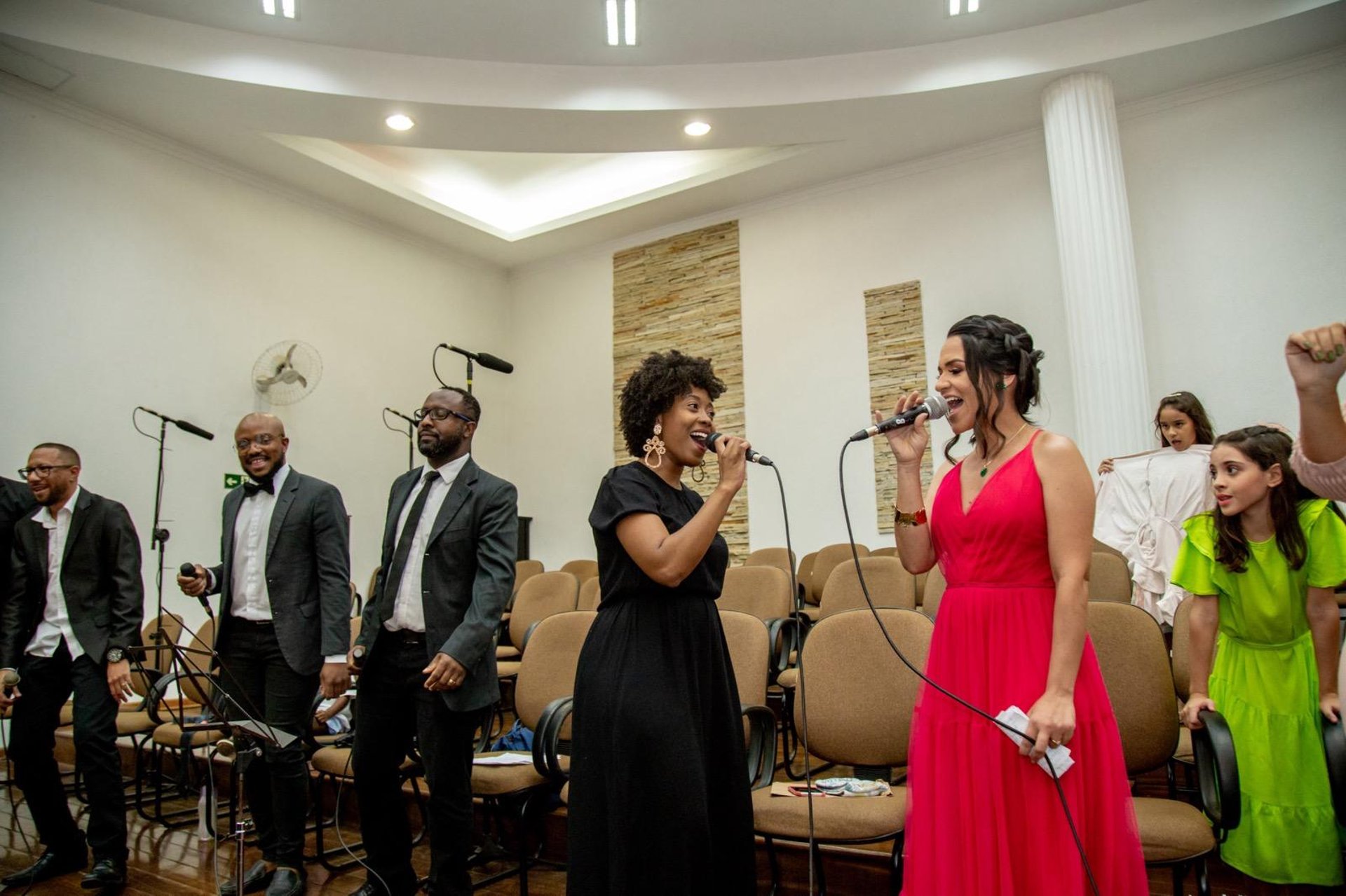 person in black and white striped shirt playing guitar