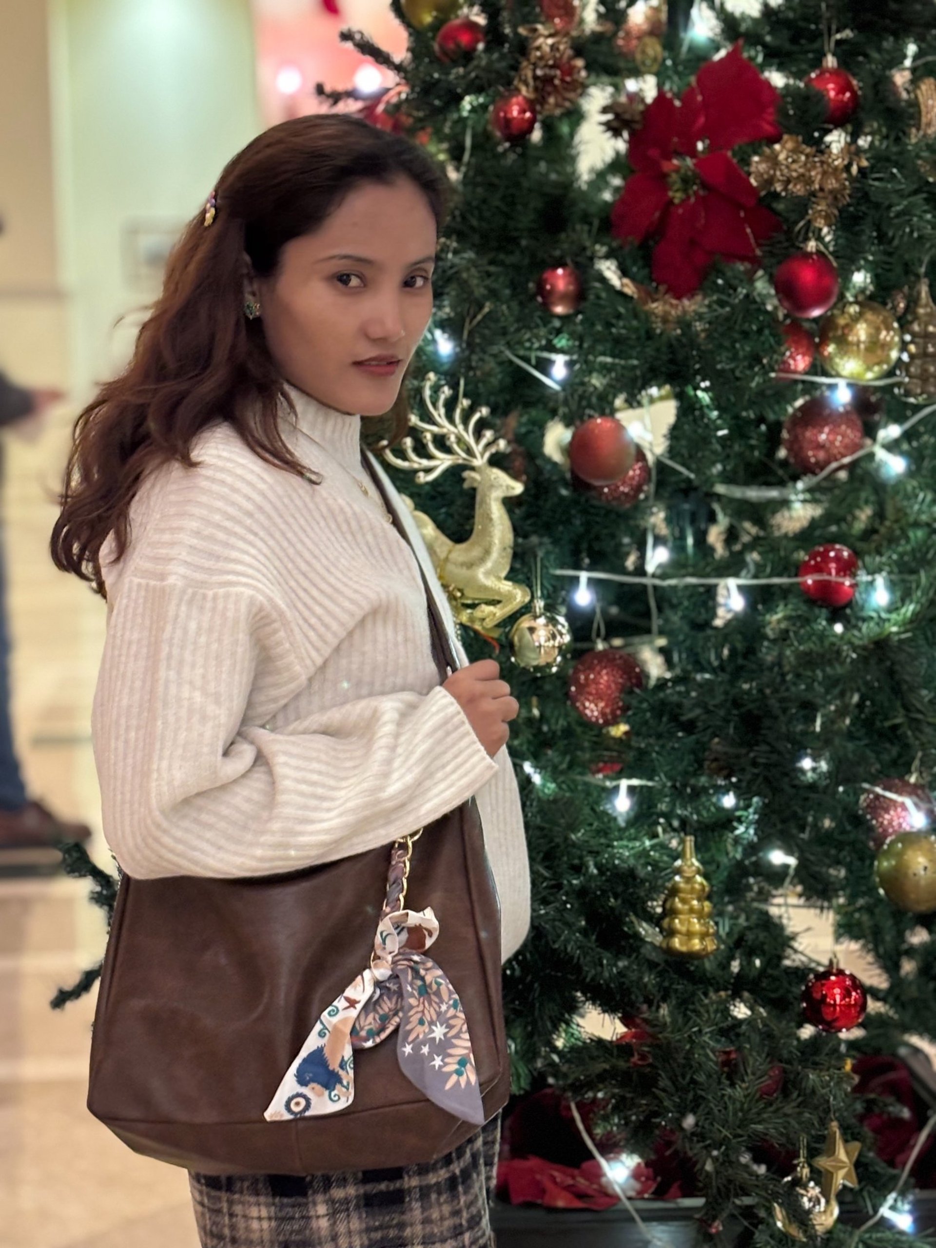 a woman in a red dress holding shopping bags