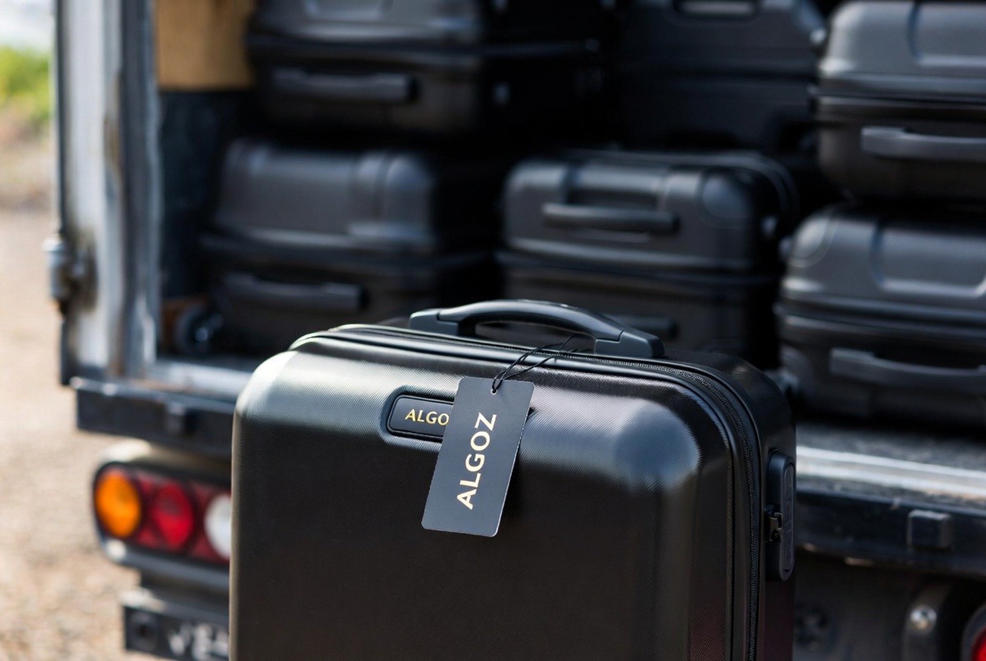 A luggage bag with a blue tag on it