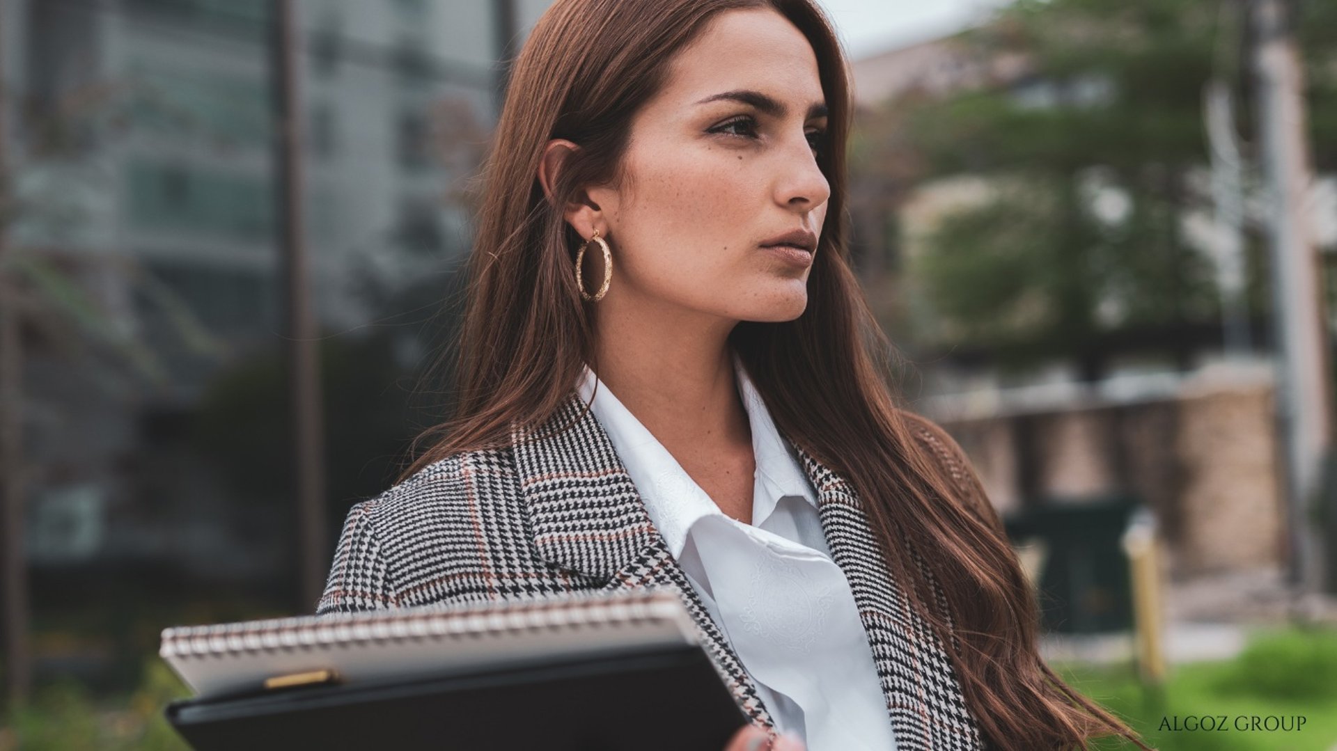 a person wearing a hat standing in front of a mountain