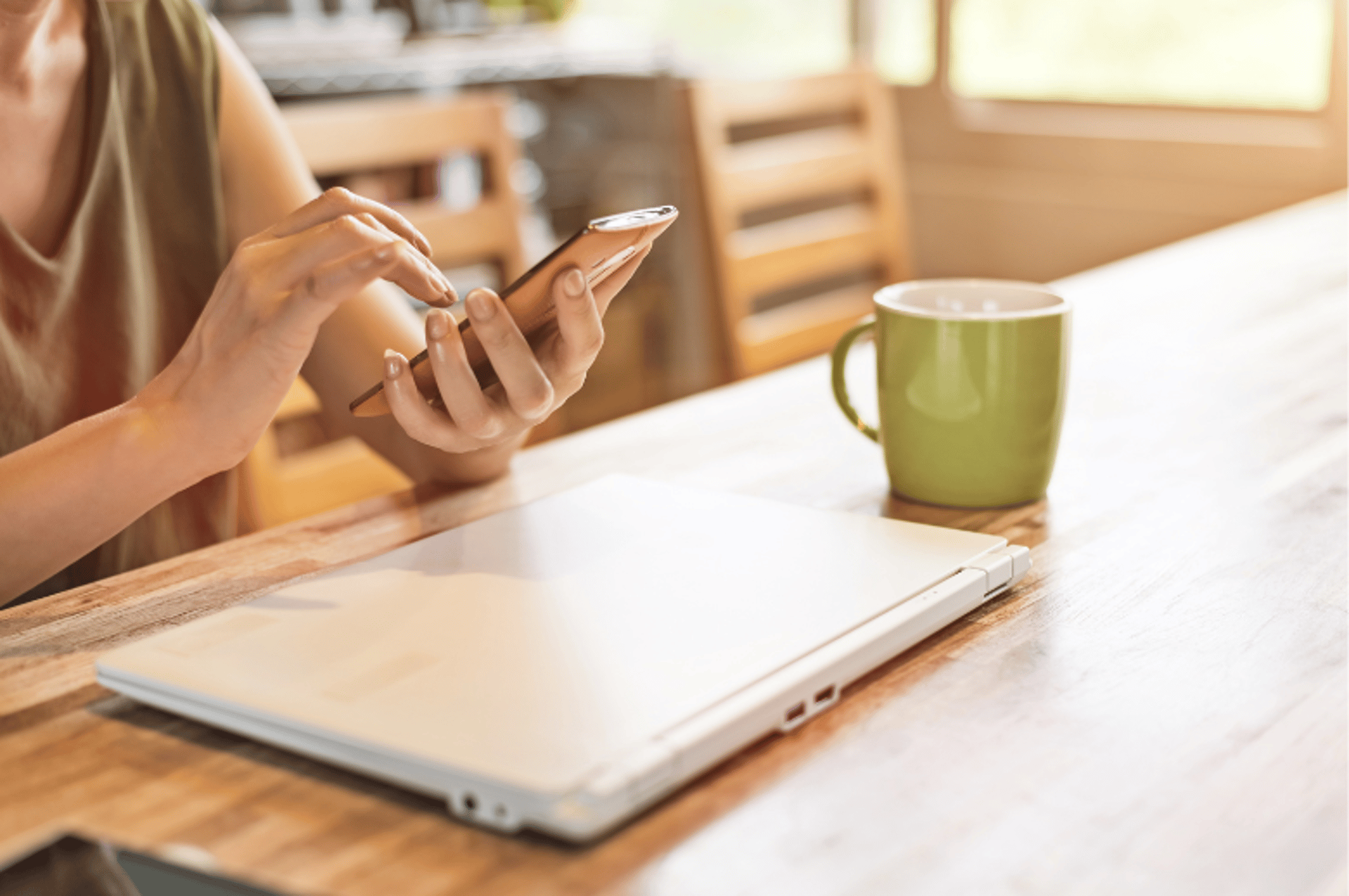 man wearing headphones while sitting on chair in front of MacBook