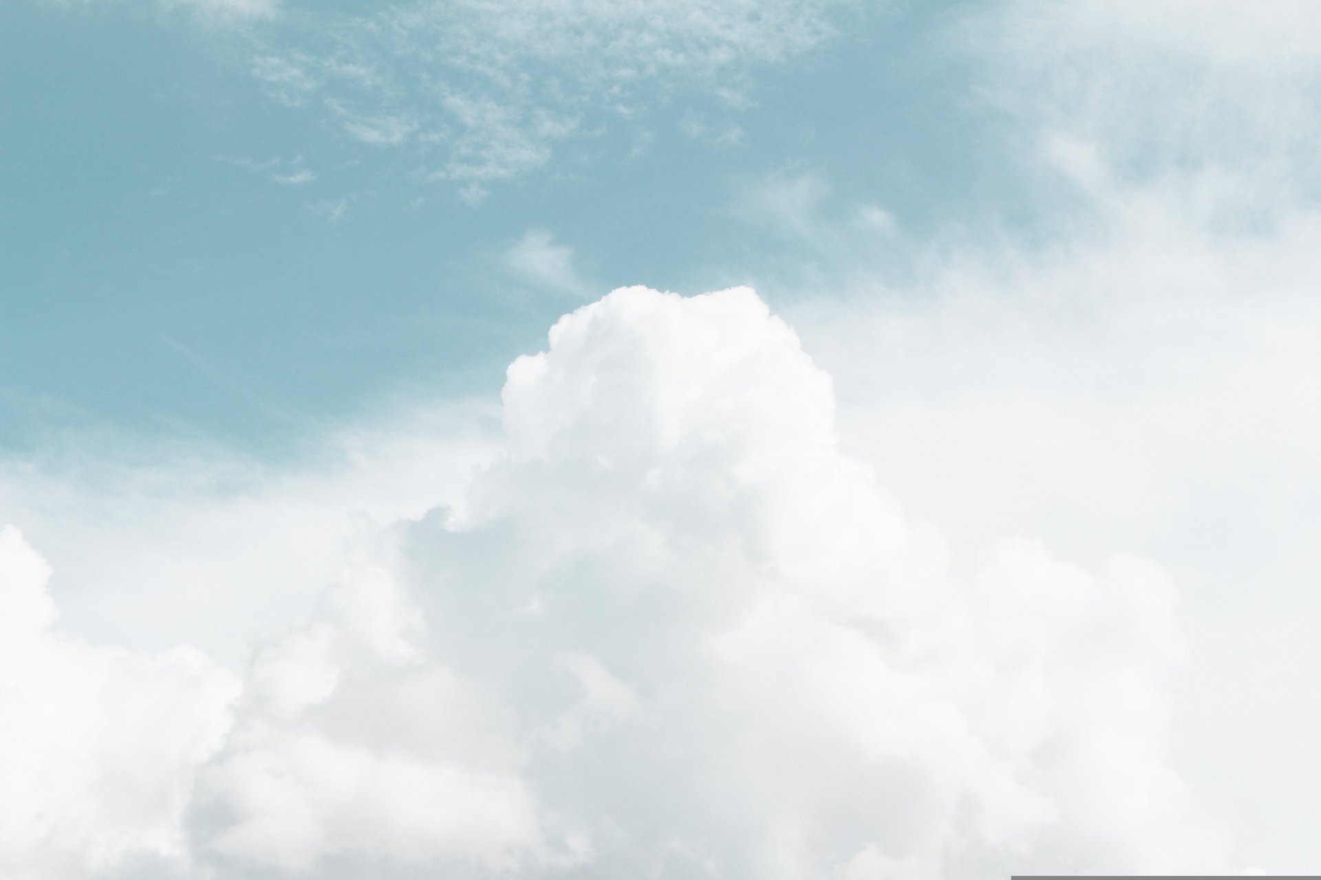 an abstract photo of a curved building with a blue sky in the background