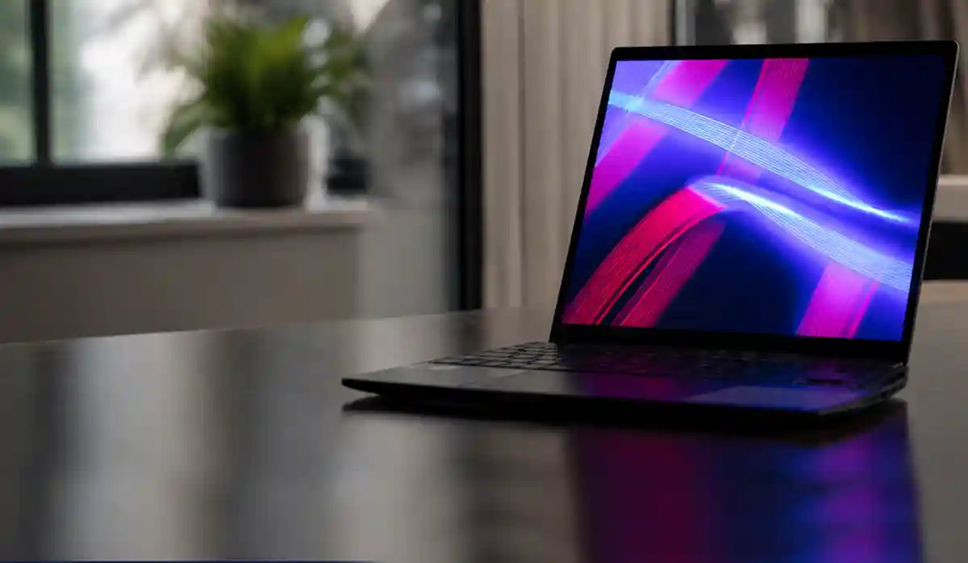 a laptop computer sitting on top of a wooden table