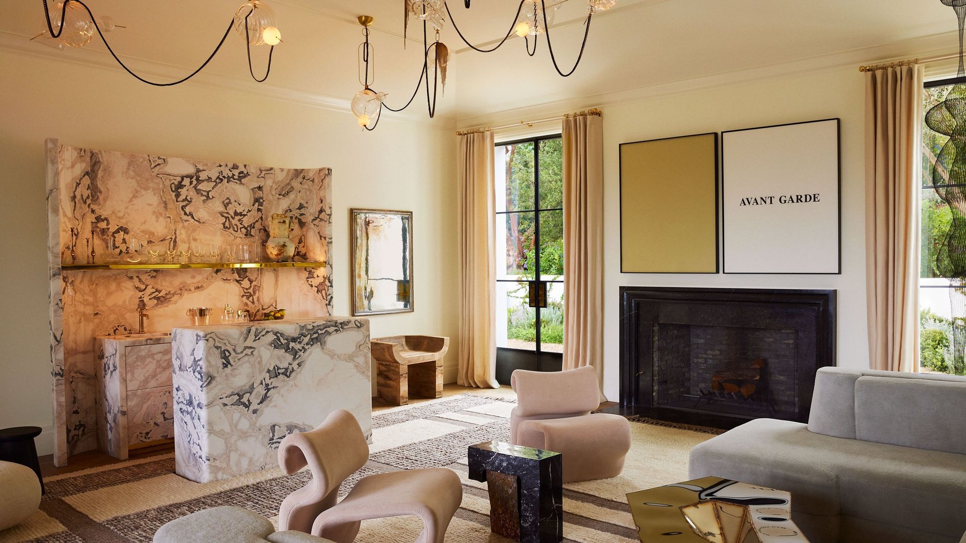 Gwyneth Paltrow’s avant-garde living room featuring marble bar, minimalist chairs, and bold wall art.