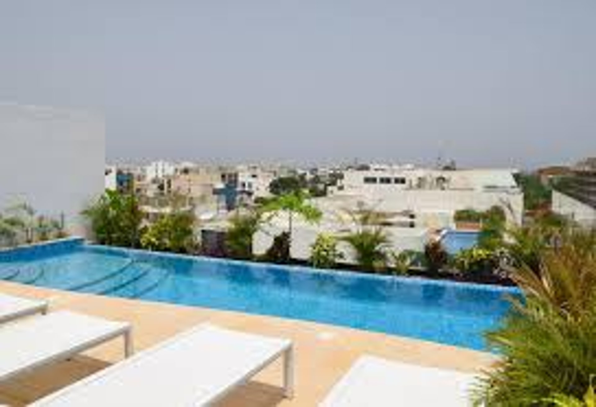 an abstract photo of a curved building with a blue sky in the background