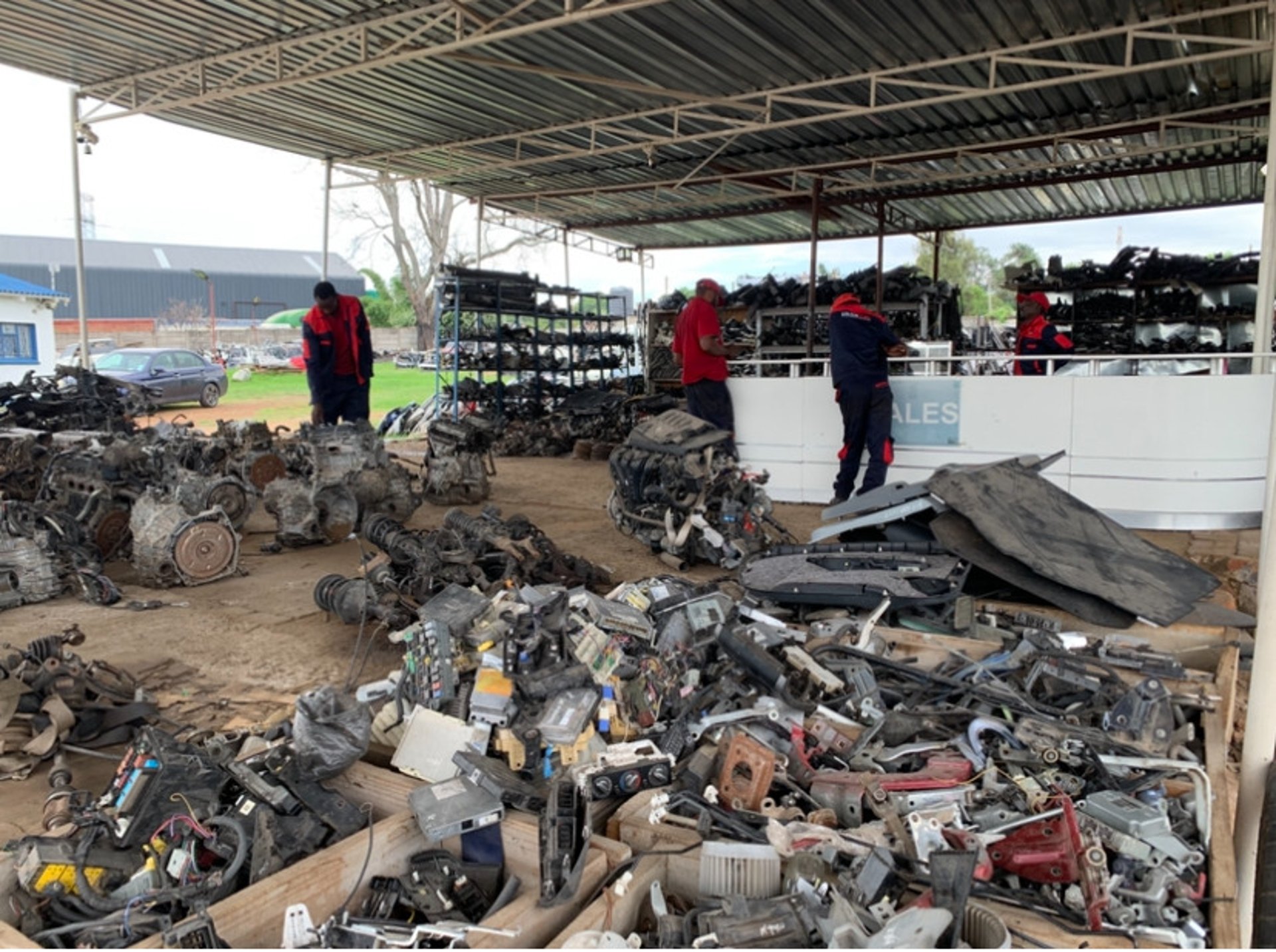 An open hood reveals the engine of a car.