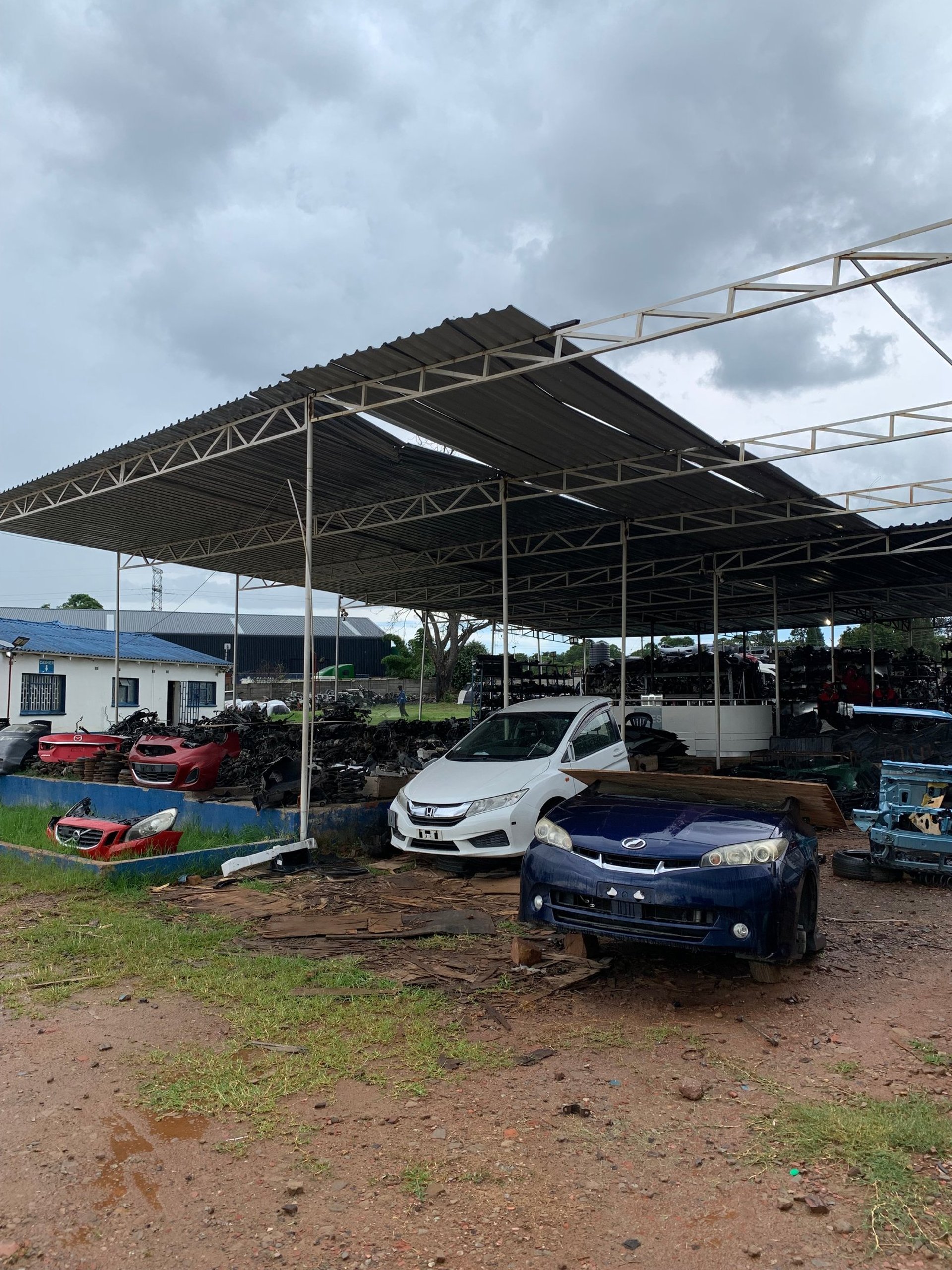 An open hood reveals the engine of a car.