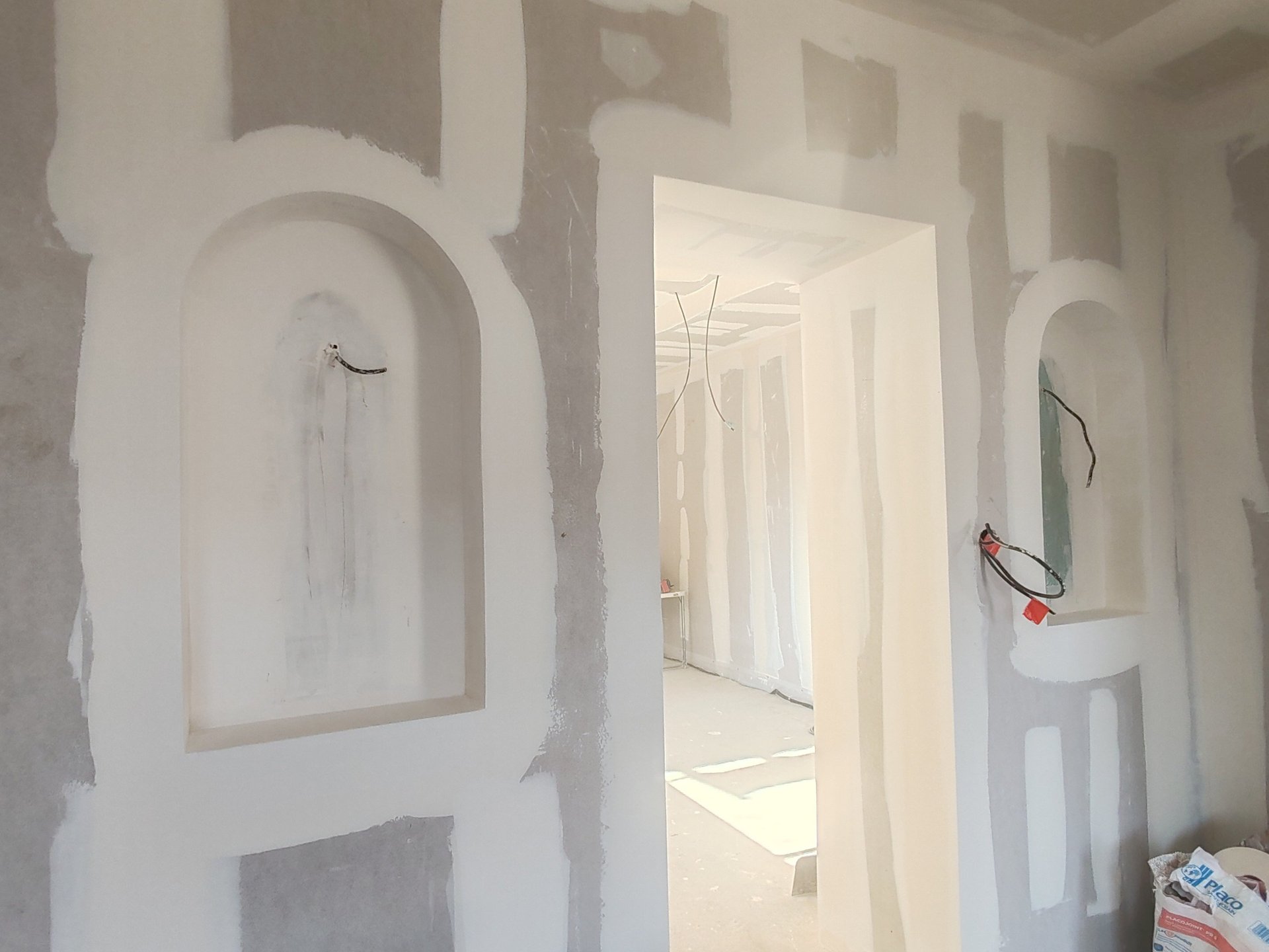 an abstract photo of a curved building with a blue sky in the background