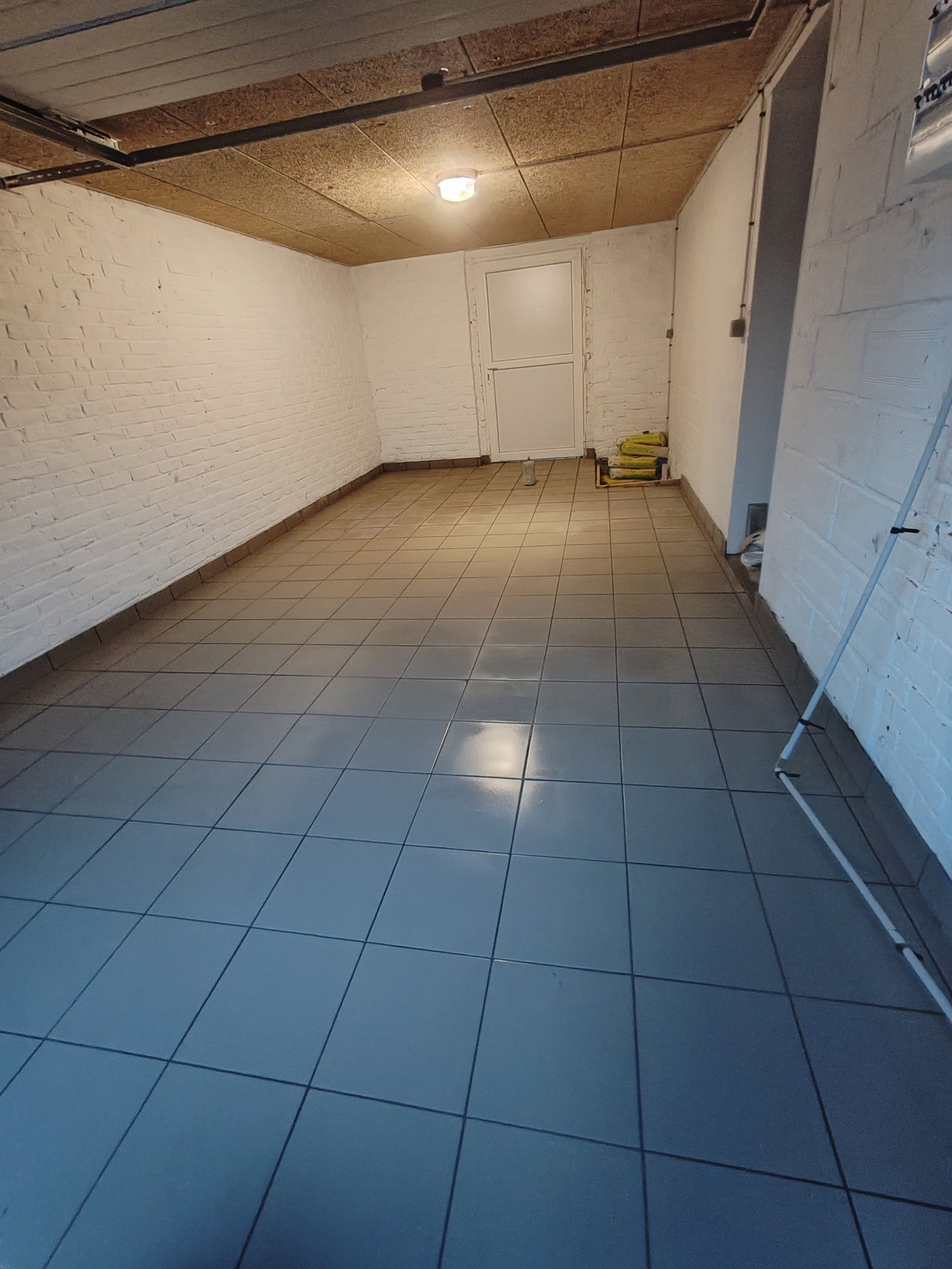 a bathroom with a marble wall and floor